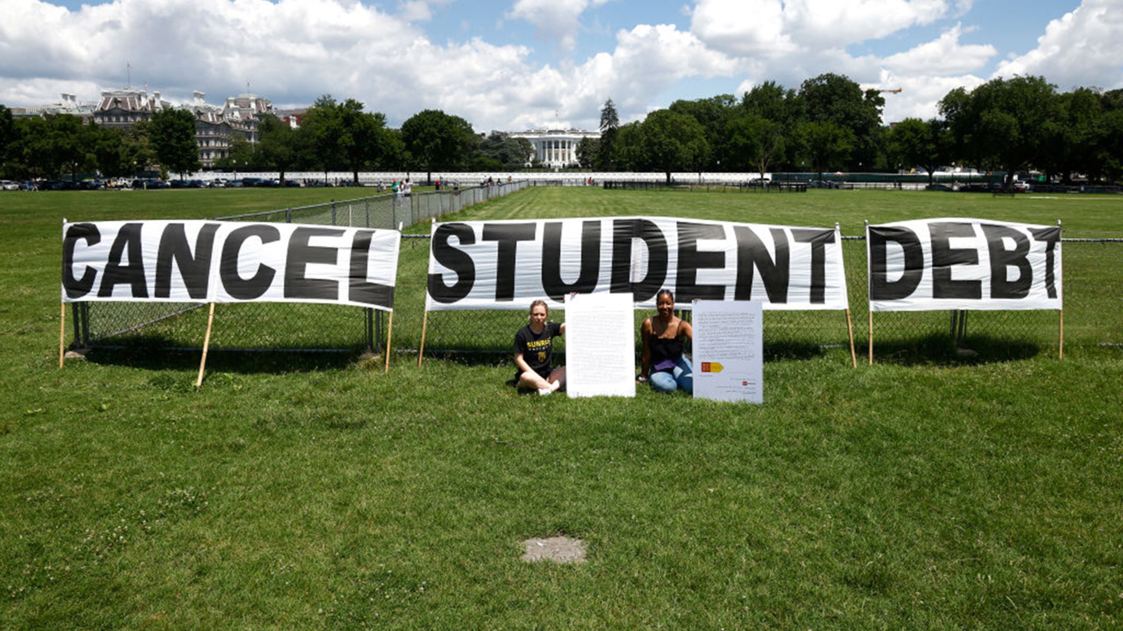 As college students around the country graduated with a massive amount of debt, advocates displayed a hand-painted sign and messages on the Ellipse in front of the White House in June. (Paul Morigi/Getty Images/TNS)