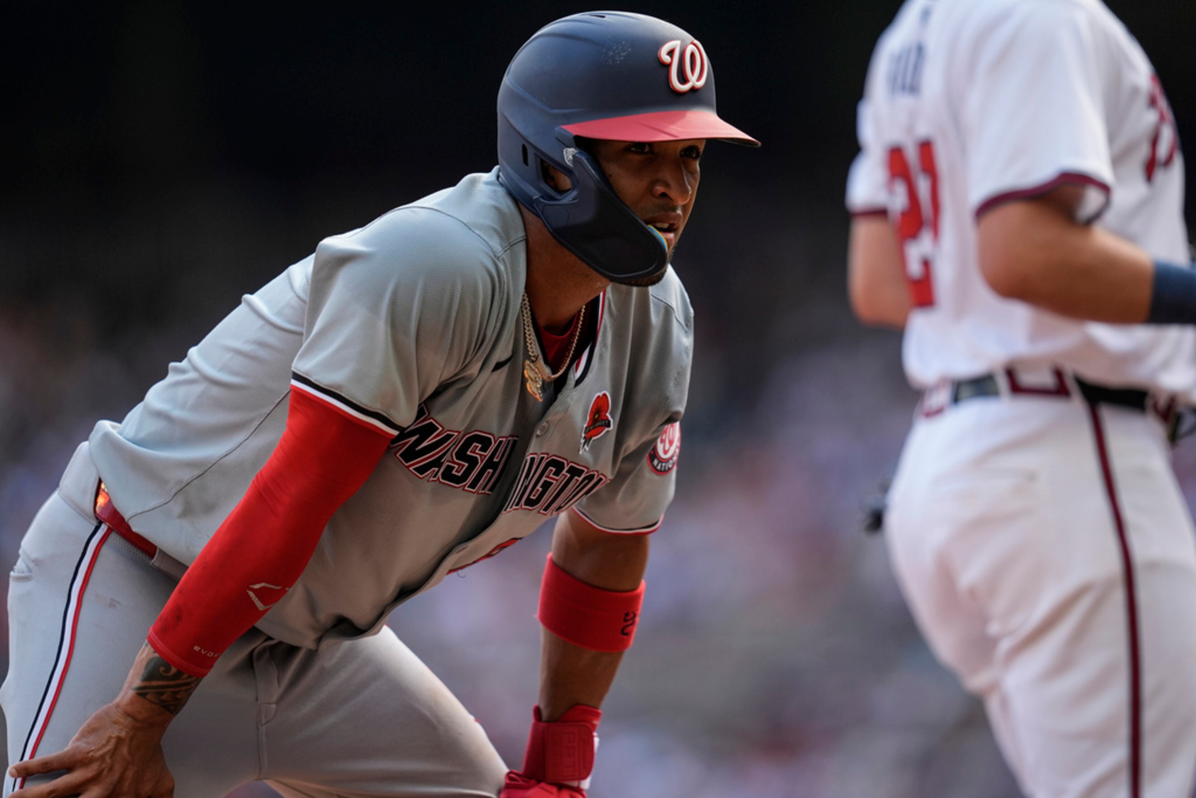 Washington Nationals outfielder Eddie Rosario (8) recoveres after stealing third base against the Atlanta Braves in the third inning of a baseball game, Monday, May 27, 2024, in Atlanta. (AP Photo/Mike Stewart)