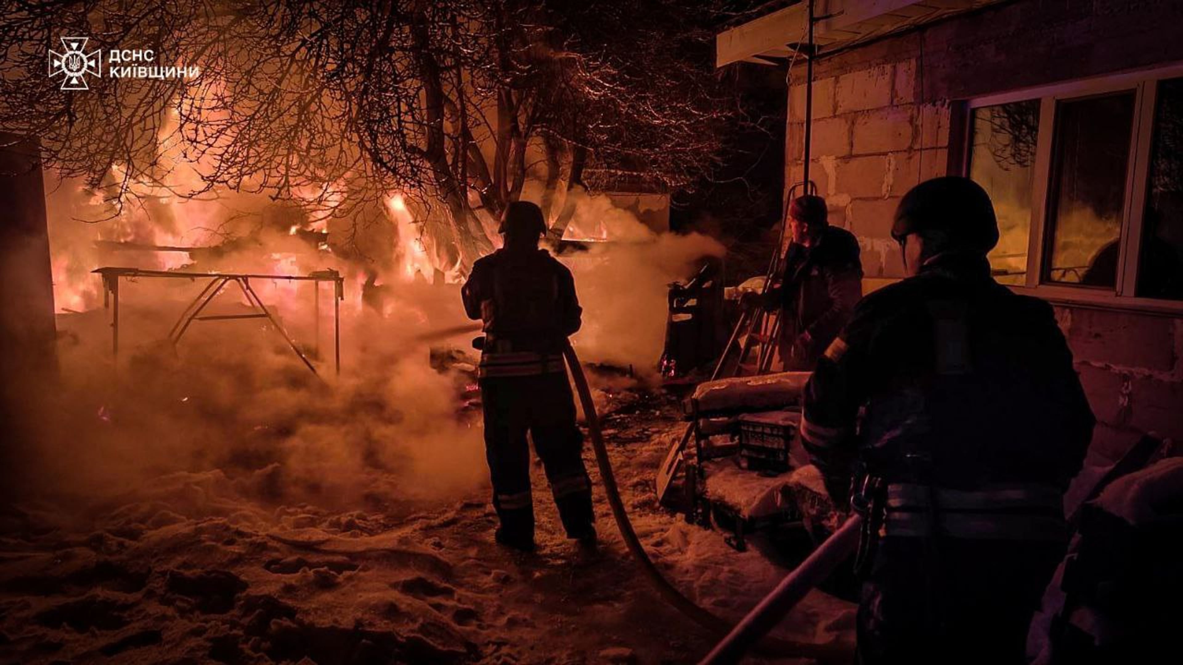 In this photo provided by the Ukrainian Emergency Service, emergency services personnel work to extinguish a fire following a Russian attack in Kyiv region, Ukraine, Tuesday, Jan. 13, 2026. (Ukrainian Emergency Service via AP)