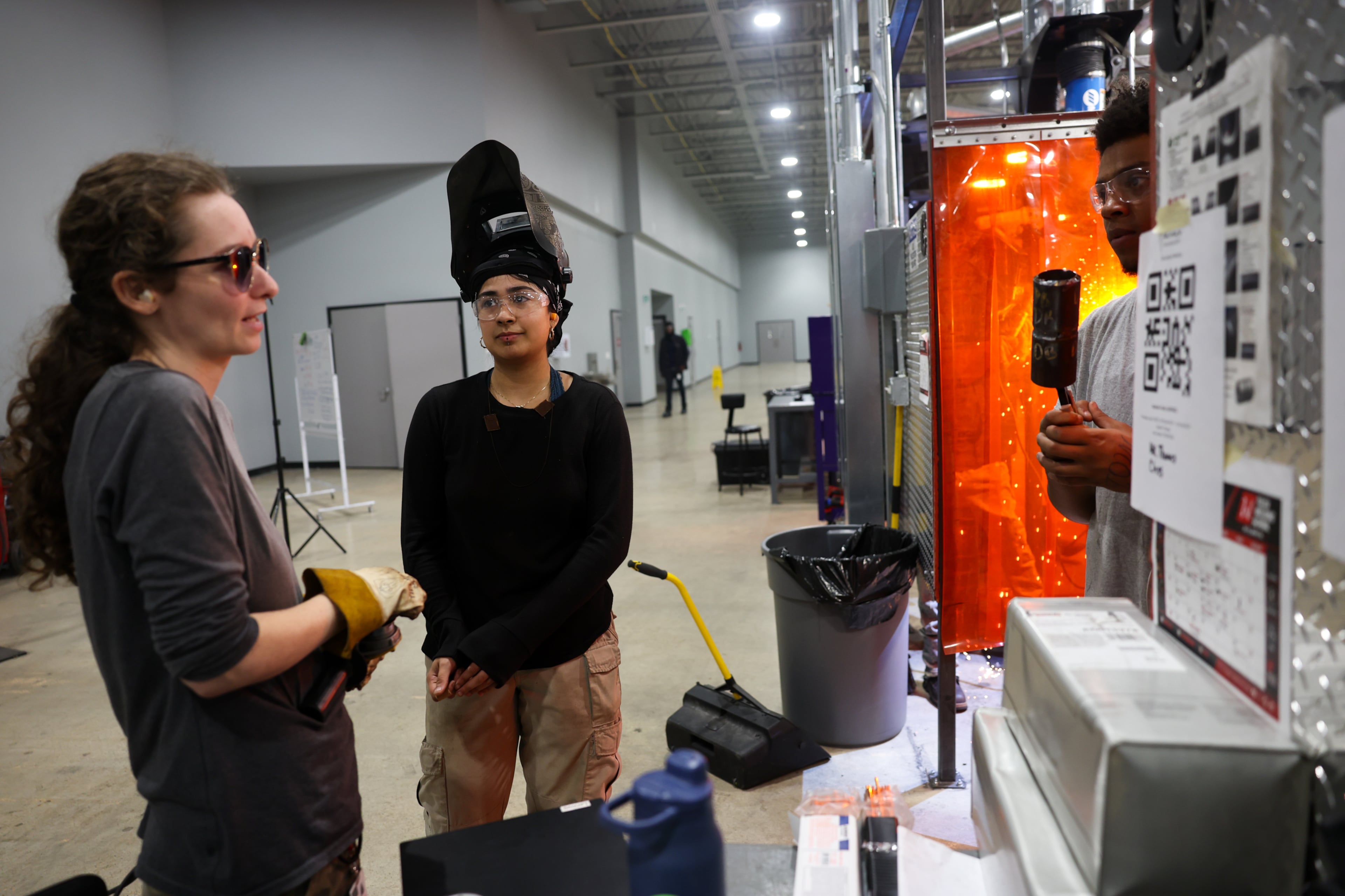 (L-R) Tulsa Welding School instructor Sabrina Emory speaks with student Jocelyn Munoz Lopez in the welding lab on the campus in Decatur on Aug. 13, 2026. (Arvin Temkar/AJC)