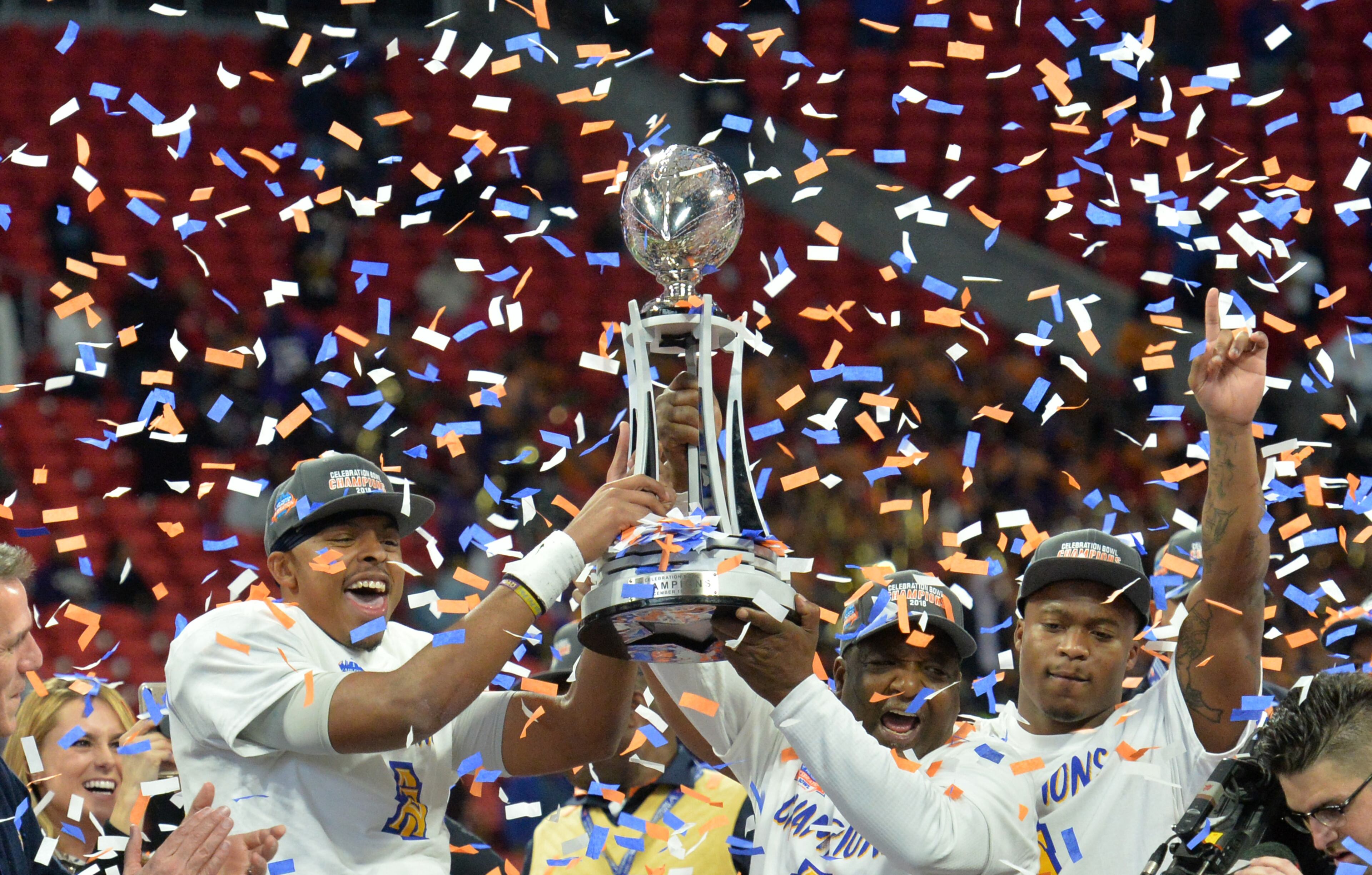 December 15, 2018 Atlanta - North Carolina A&T head coach Sam Washington and players celebrate with the championship trophy during the 2018 Celebration Bowl at Mercedes-Benz Stadium on Saturday, December 15, 2018. North Carolina A&T won 24-22 over the Alcorn State. HYOSUB SHIN / HSHIN@AJC.COM