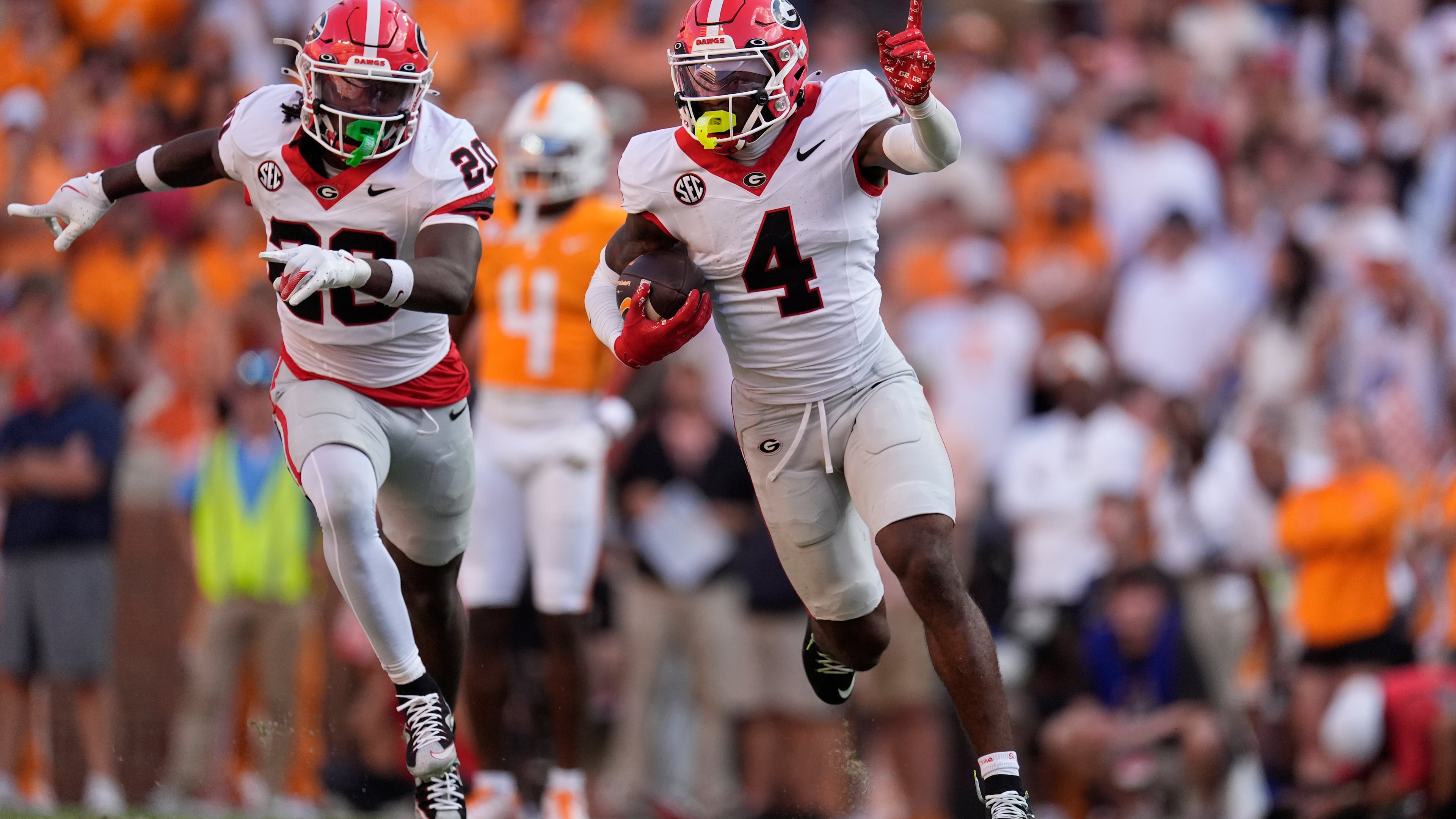 FILE - Georgia defensive back KJ Bolden (4) celebrates an interception with teammate JaCorey Thomas (20) during the second half of an NCAA college football game against Tennessee, Sept. 13, 2025, in Knoxville, Tenn. (AP Photo/George Walker IV, File)
