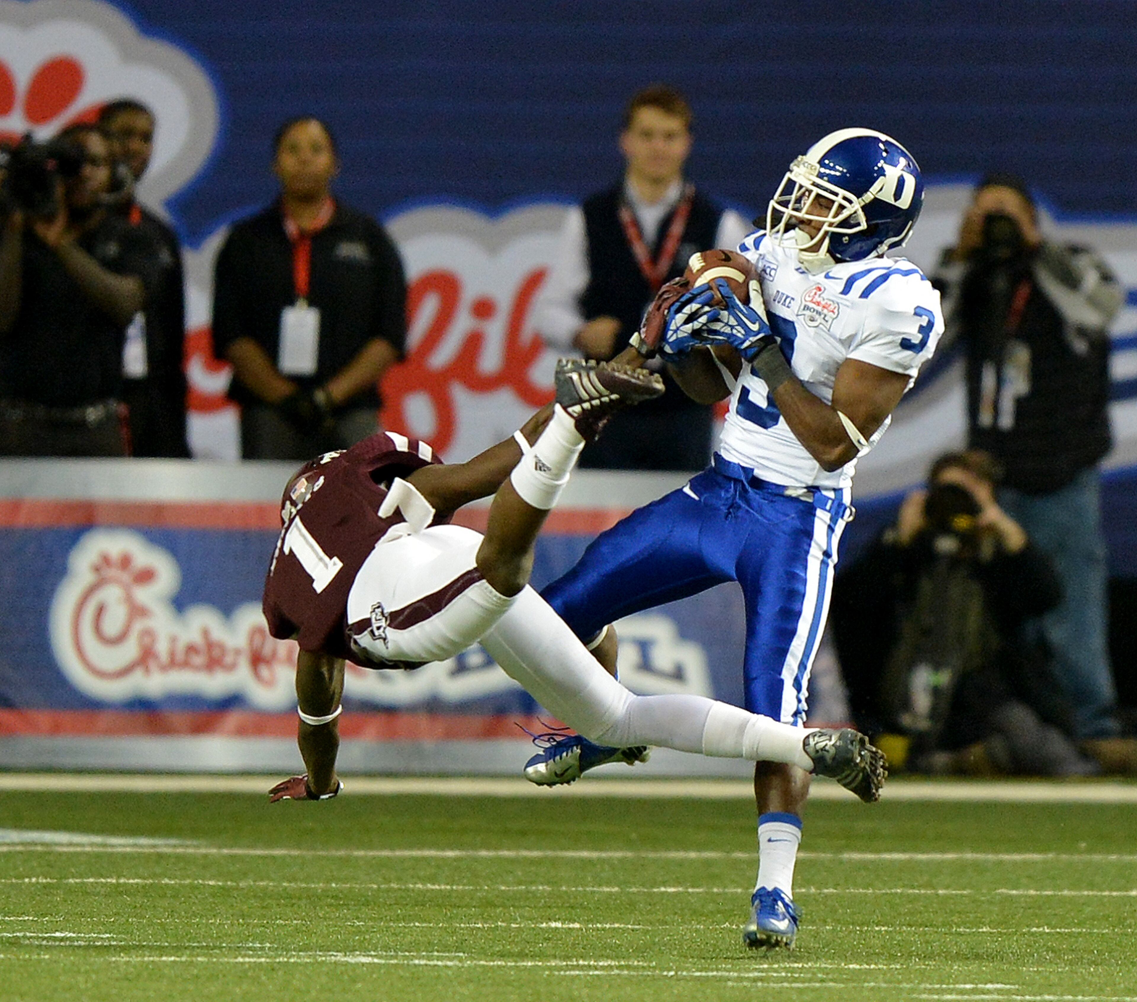 Duke wide receiver Jamison Crowder beats Texas A&M defensive back De'Vante Harris deep on the Blue Devils opening play, but can't hold on to the ball in the Chick-fil-A Bowl on Tuesday, Dec. 31, 2013.