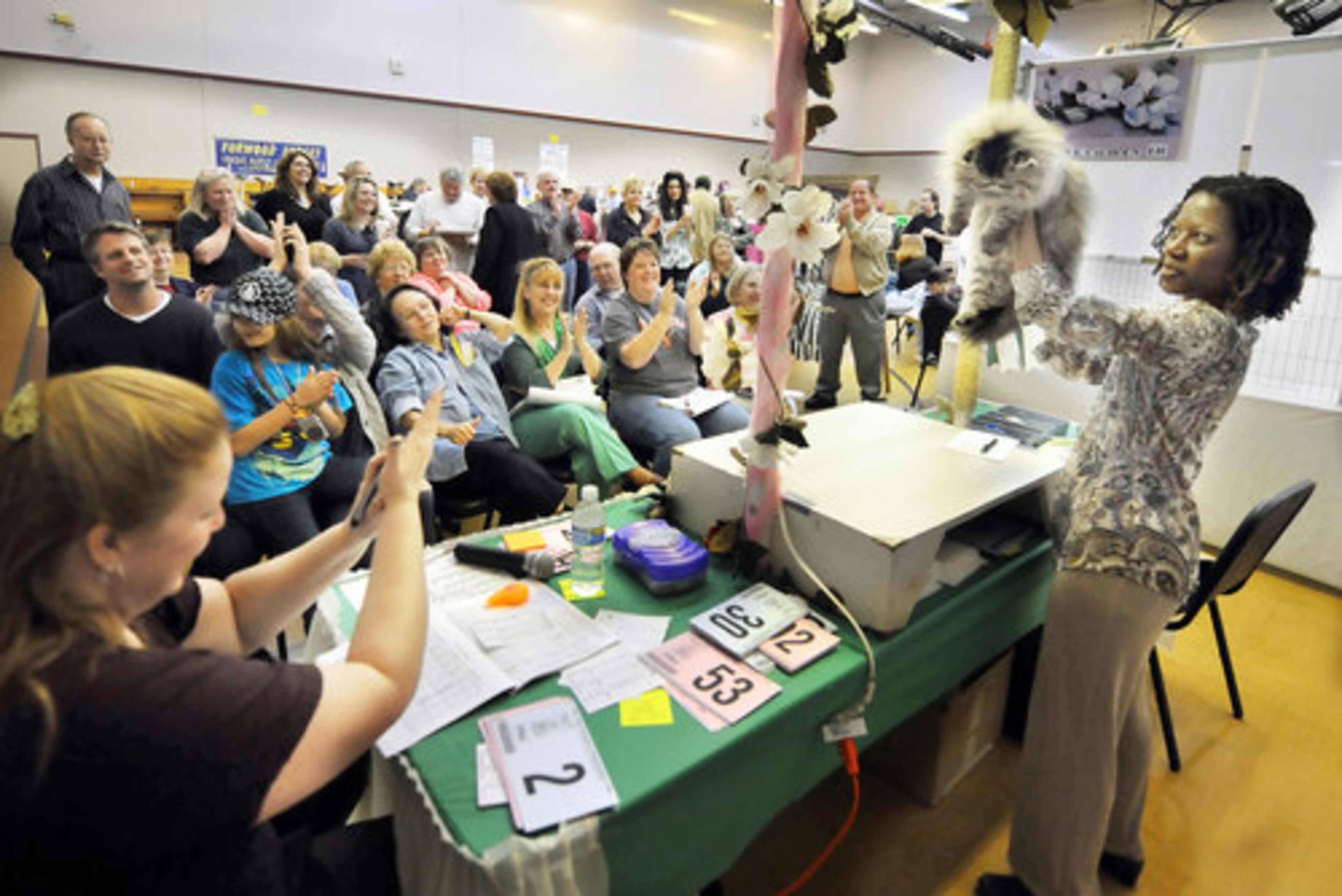 JUDGE KATHY Calhoun of Chicago holds up "Jonti Dream A Little Dream," a brown mackerel Persian, after she won the long-hair kitten category.