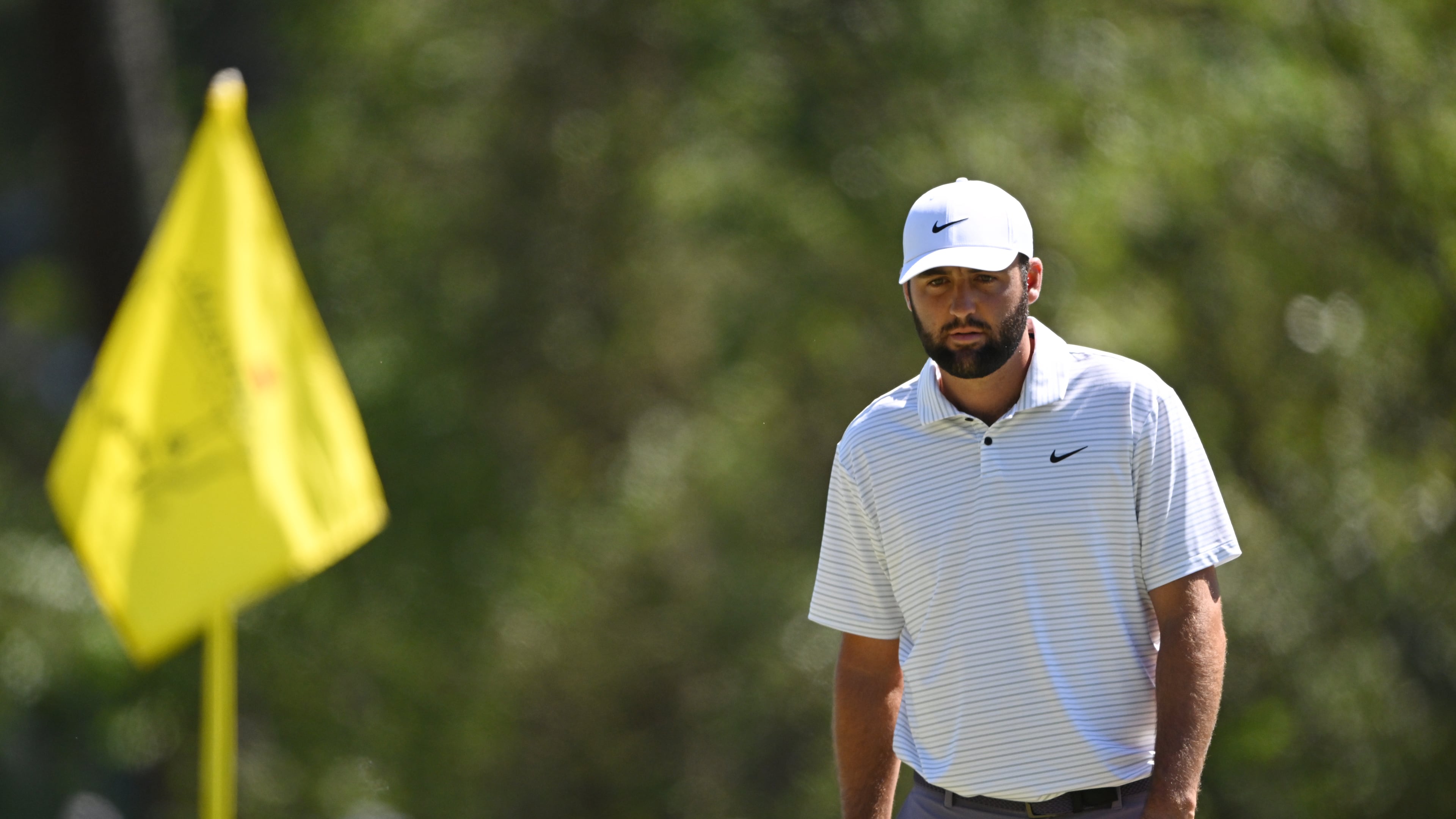 Scottie Scheffler lines up putt on third green during third round at the 2024 Masters Tournament at Augusta National Golf Club, Saturday, April 13, 2024, in Augusta, Ga. (Hyosub Shin/AJC)
