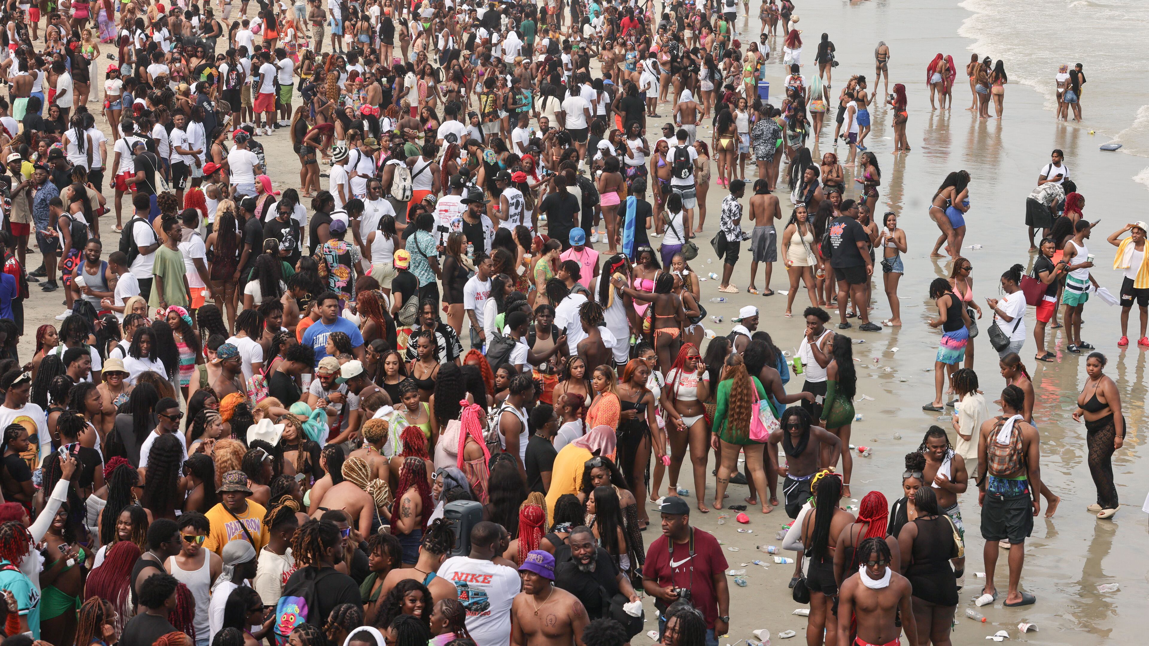 A crowd of spring break partiers gather on the beach for Orange Crush in Tybee Island on Saturday, April 20, 2024. Most metro Atlanta universities will have spring break within the next few weeks. (Natrice Miller/ AJC)