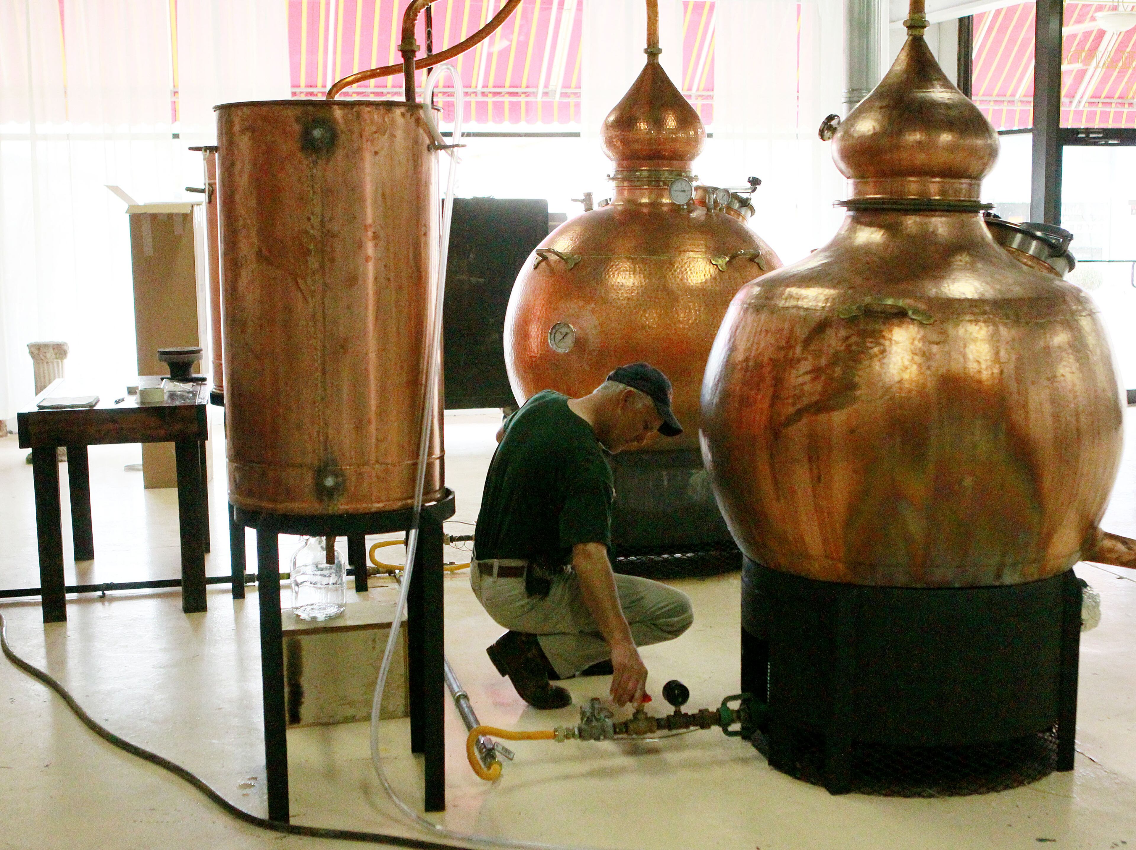 Master Distiller Jay McCain checks the temperature of the stills made in Portugal.
