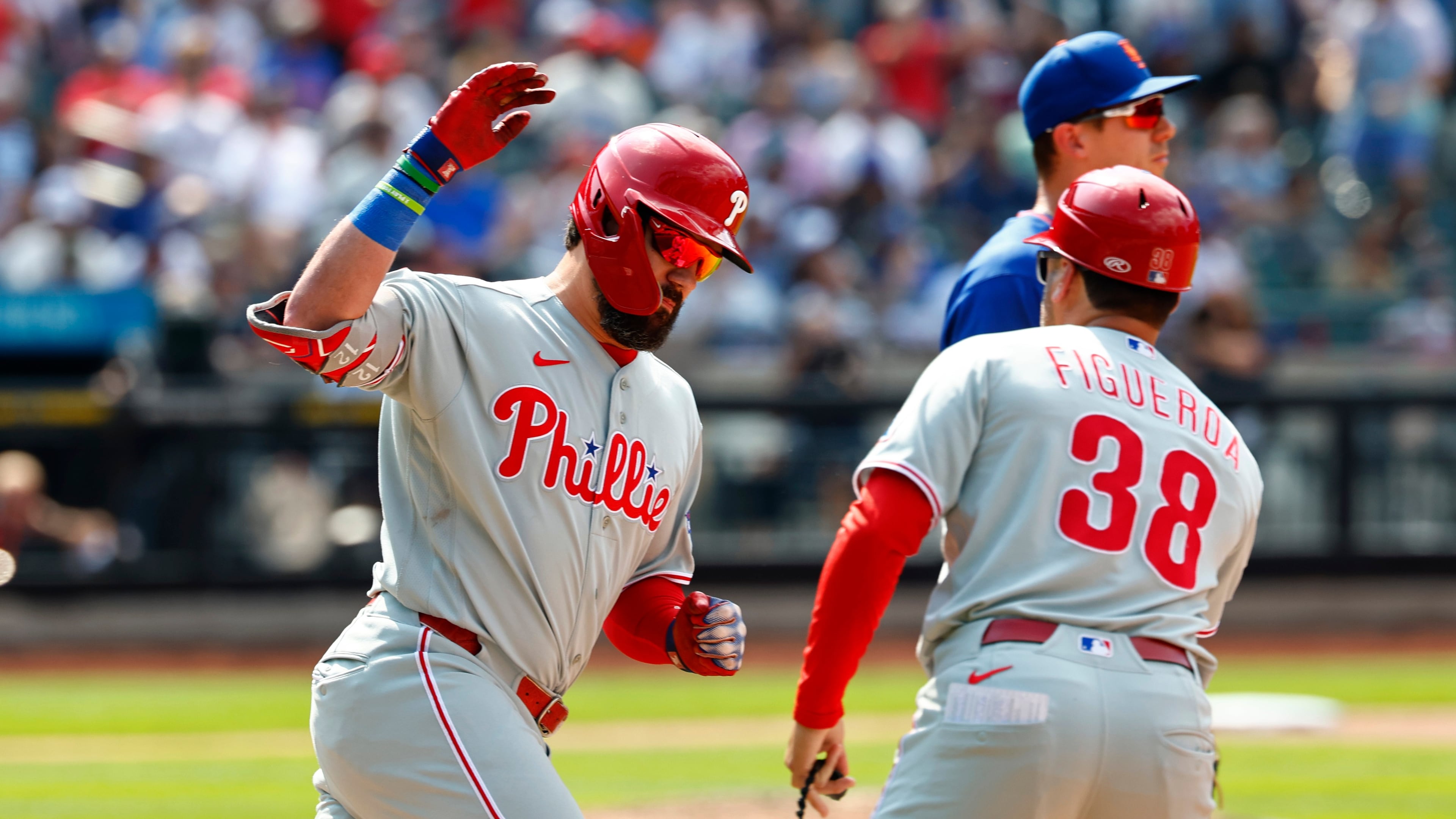 Philadelphia Phillies' Kyle Schwarber, left, celebrates with first base coach Paco Figueroa (38) after hitting a two-run home run against the New York Mets during the seventh inning of a baseball game, Sunday, June 28, 2026, in New York. (AP Photo/Noah K. Murray)