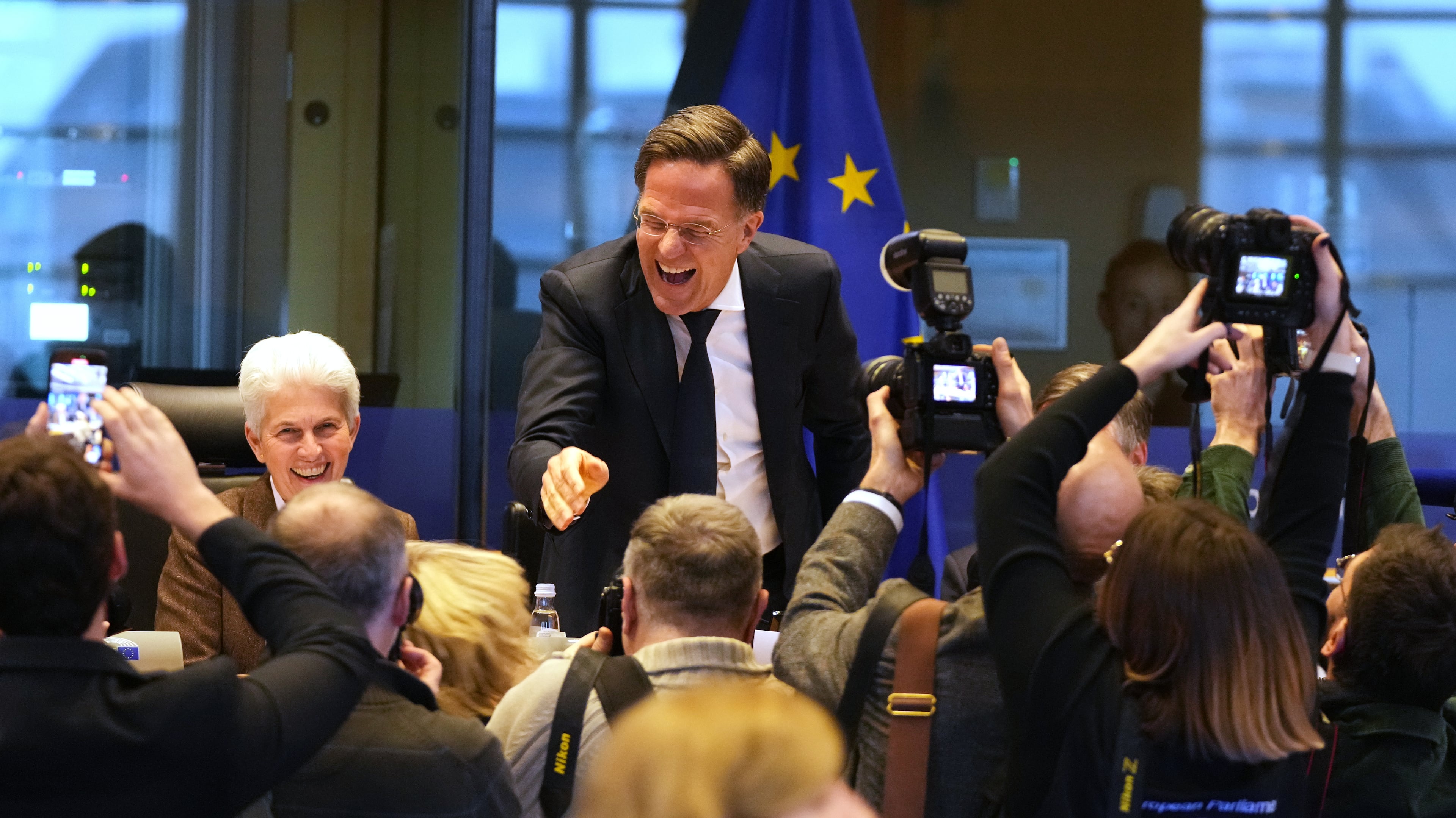 NATO Secretary General Mark Rutte, center, greets the audience prior to his address during the Security and Defence Committee at the European Parliament in Brussels, Monday, Jan. 26, 2026. (AP Photo/Virginia Mayo)