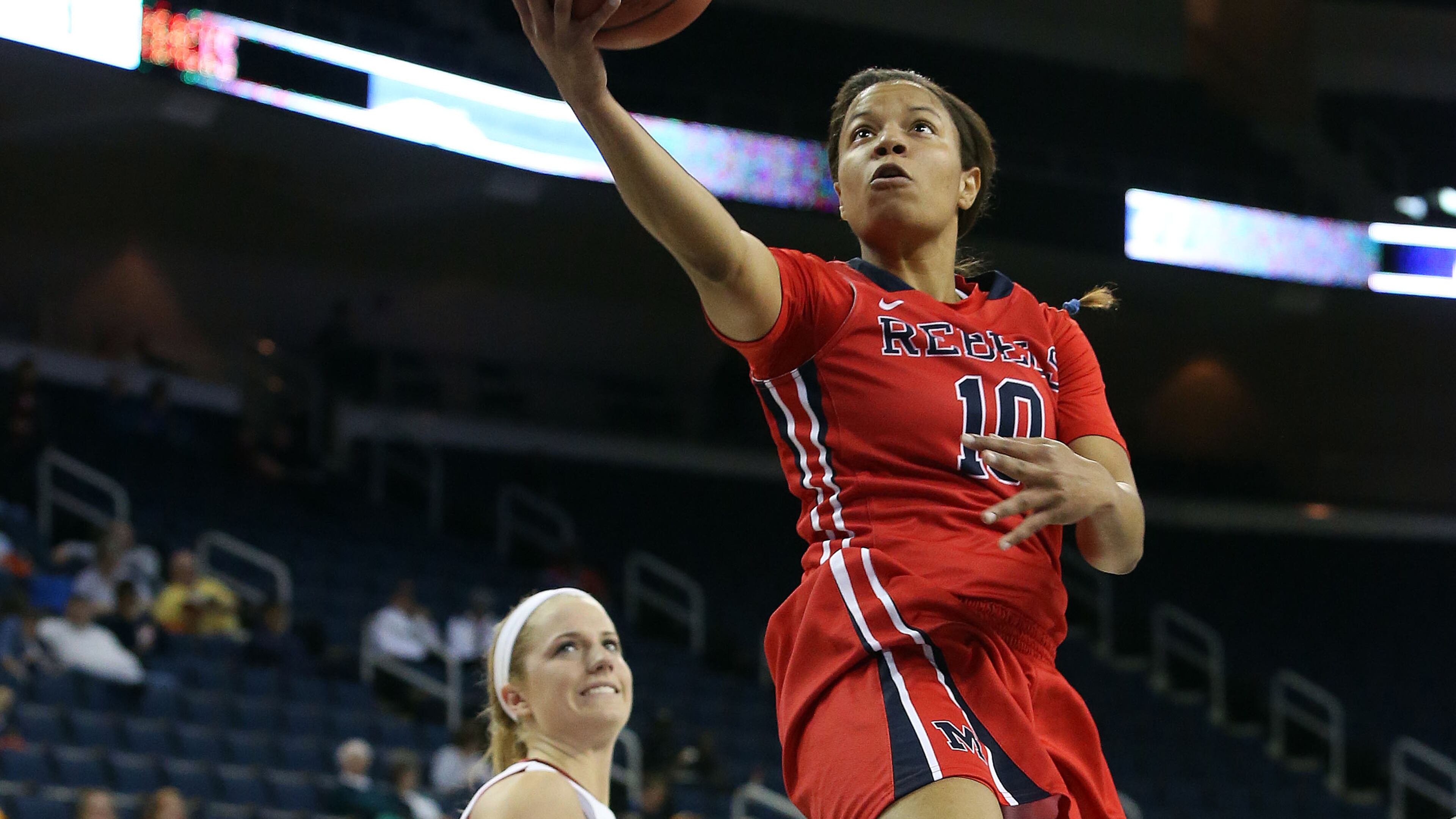 Mississippi guard Diara Moore (10) goes up for a basket as Arkansas guard Calli Berna (11) looks on in the first half of a first-round women's Southeastern Conference tournament NCAA college basketball game Wednesday, March 5, 2014, in Duluth, Ga.