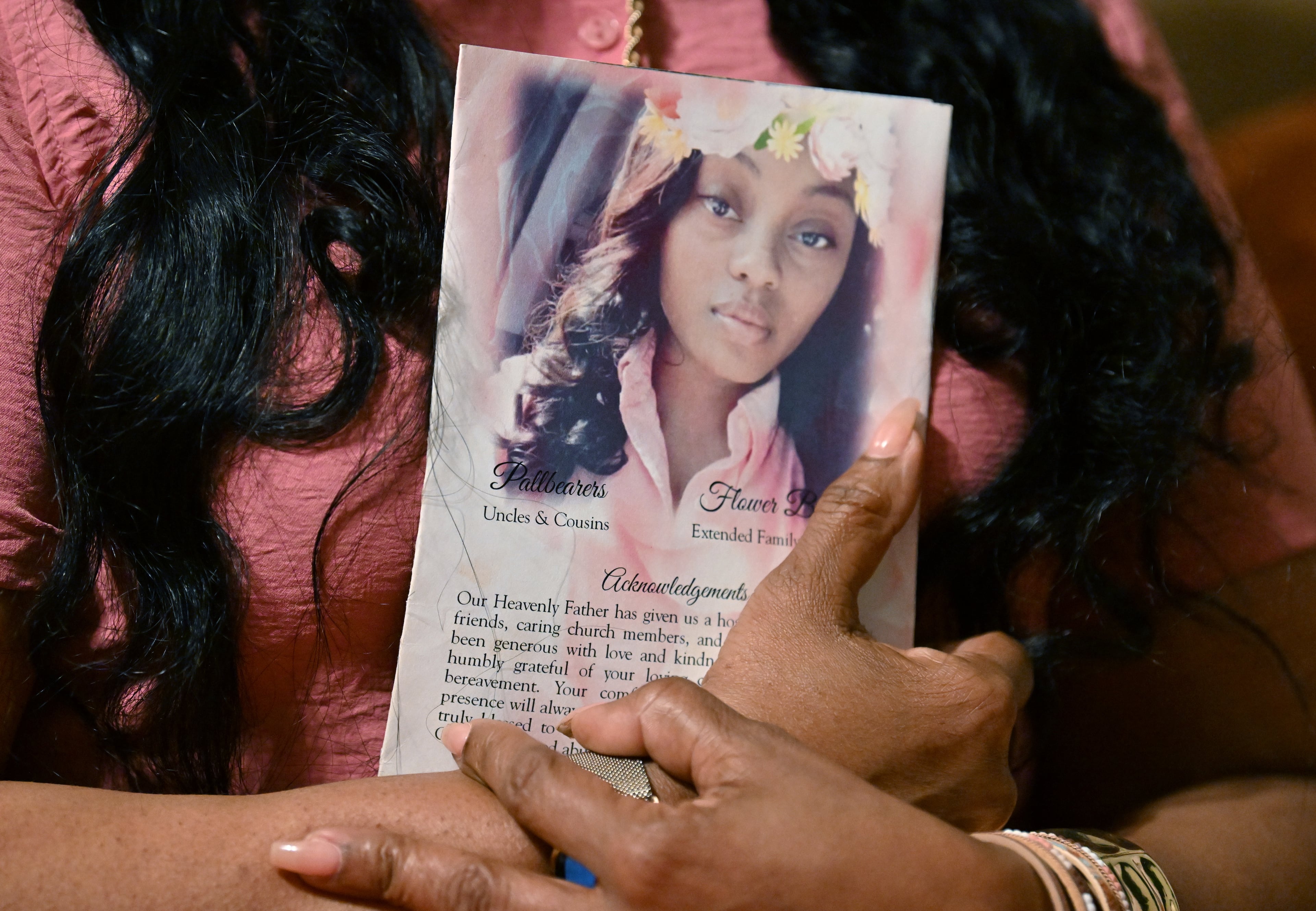 Shanette Williams, whose daughter Amber Nicole Thurman died after a delay in emergency medical care tied to Georgia’s abortion ban, holds a funeral service program at her home, Wednesday, April 29, 2026, in Covington, Ga. (Hyosub Shin/AJC)
