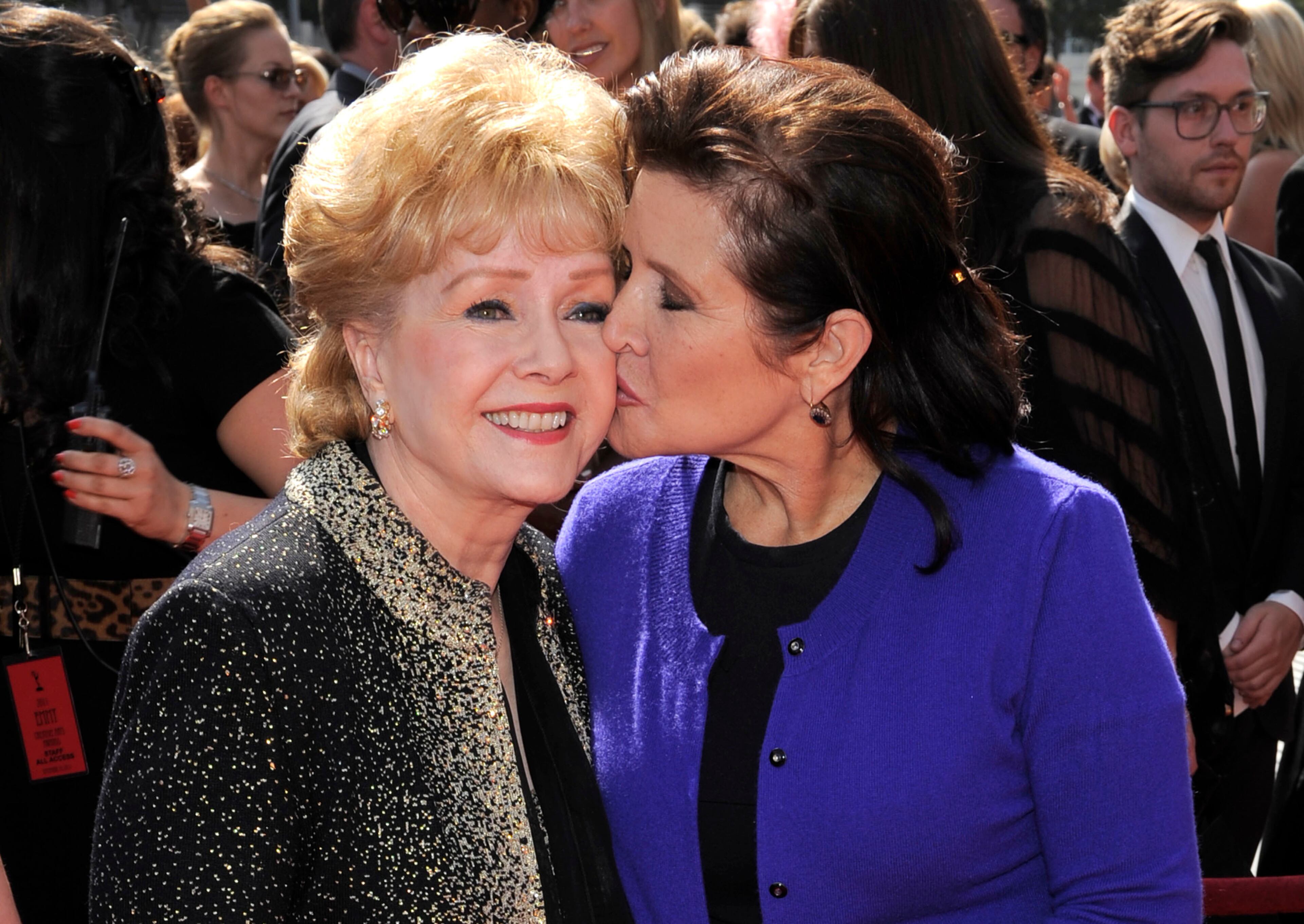 In this Sept. 10, 2011, file photo, Debbie Reynolds, left, and Carrie Fisher arrive at the Primetime Creative Arts Emmy Awards in Los Angeles. (AP Photo/Chris Pizzello, File)