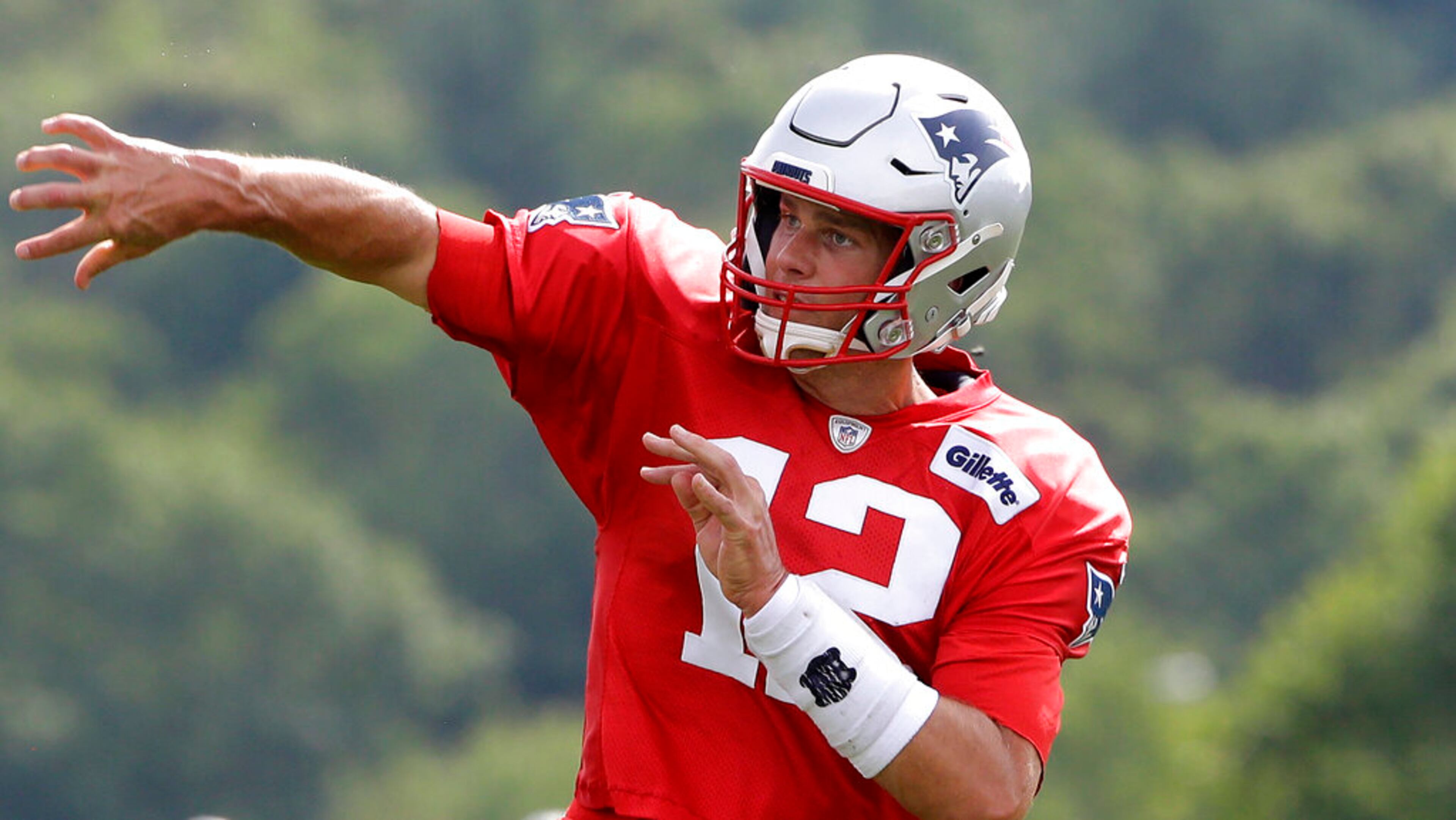 New England Patriots quarterback Tom Brady follows through on a pass during an NFL football training camp practice, Thursday, Aug. 1, 2019, in Foxborough, Mass. (AP Photo/Steven Senne)