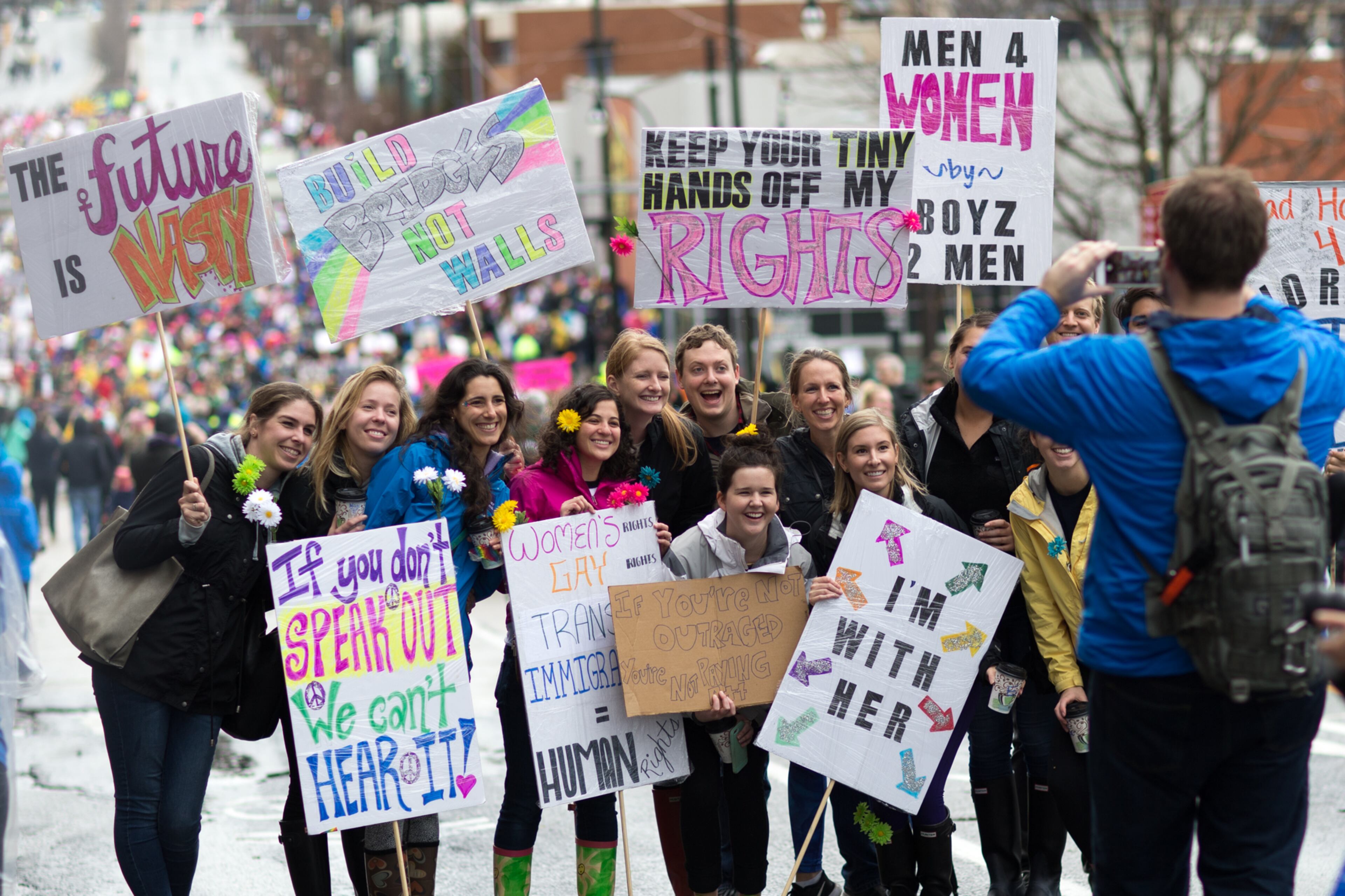 People pose for a photo with signs during the Atlanta March for Social Justice & Women, Saturday, Jan. 21, 2017, in Atlanta. BRANDEN CAMP/SPECIAL