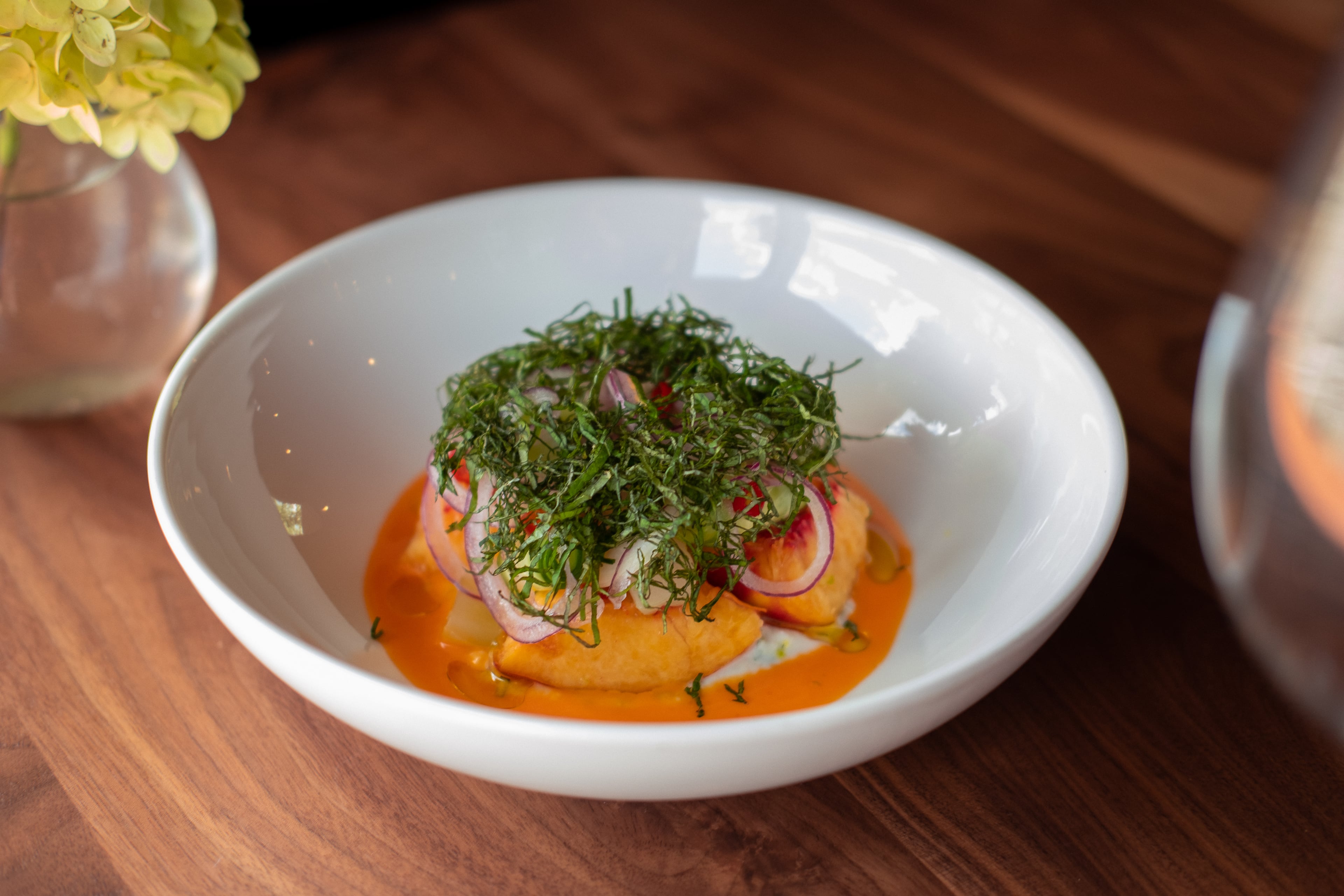 A peach and perilla salad at Spring Marietta (about 15 minutes from Kennesaw State University) is made with Pearson Farm peaches at the height of the summer season. The peppers, cucumbers and red onions are from Straight from the Backyard Farm. (Dashi Dugarzapovic, courtesy of Spring Marietta)