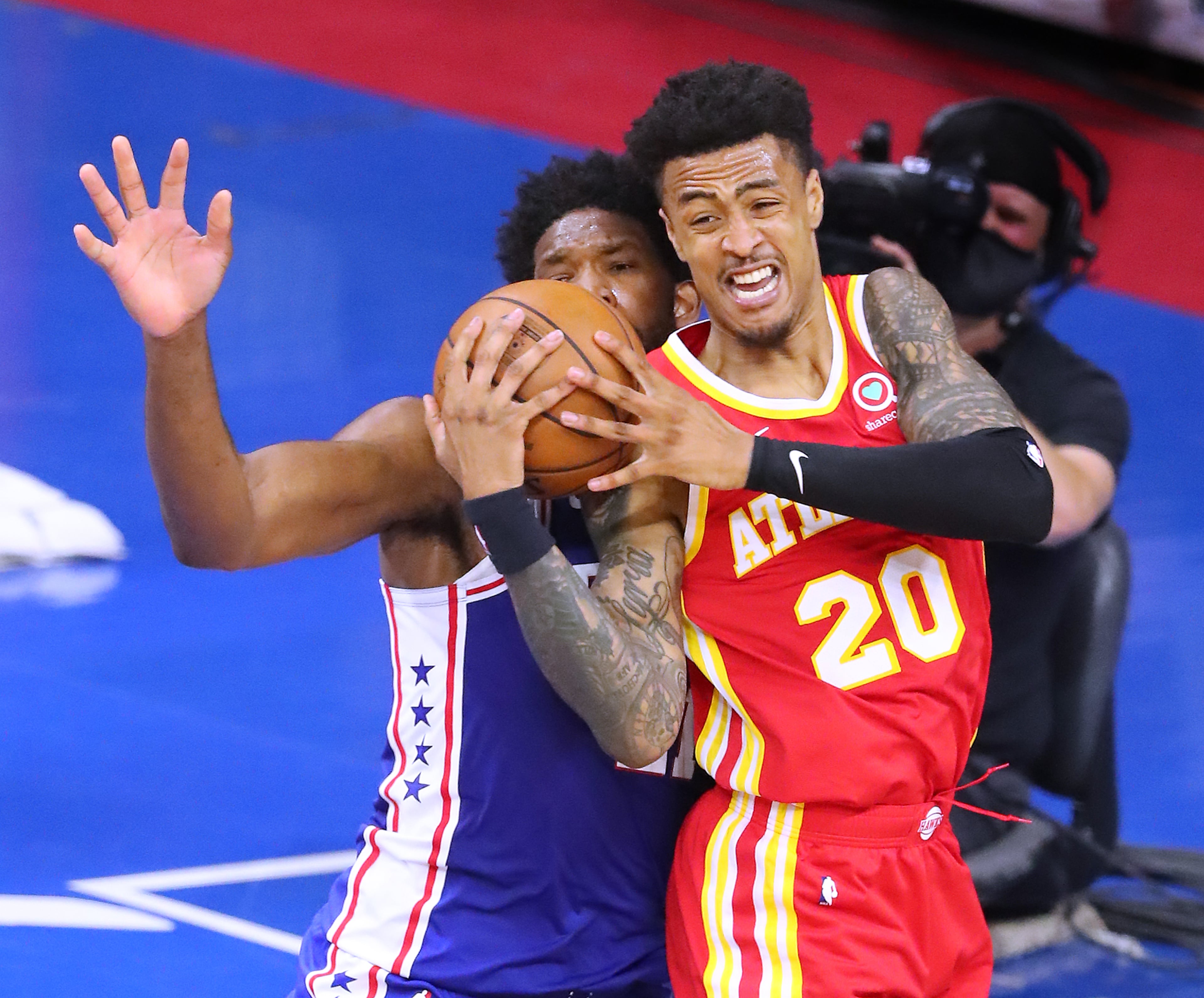 Atlanta Hawks forward John Collins battles for the ball with Philadelphia 76ers center Joel Embiid in game 2 of their NBA Eastern Conference semifinals series on Tuesday, June 8, 2021, in Philadelphia. “Curtis Compton / Curtis.Compton@ajc.com”