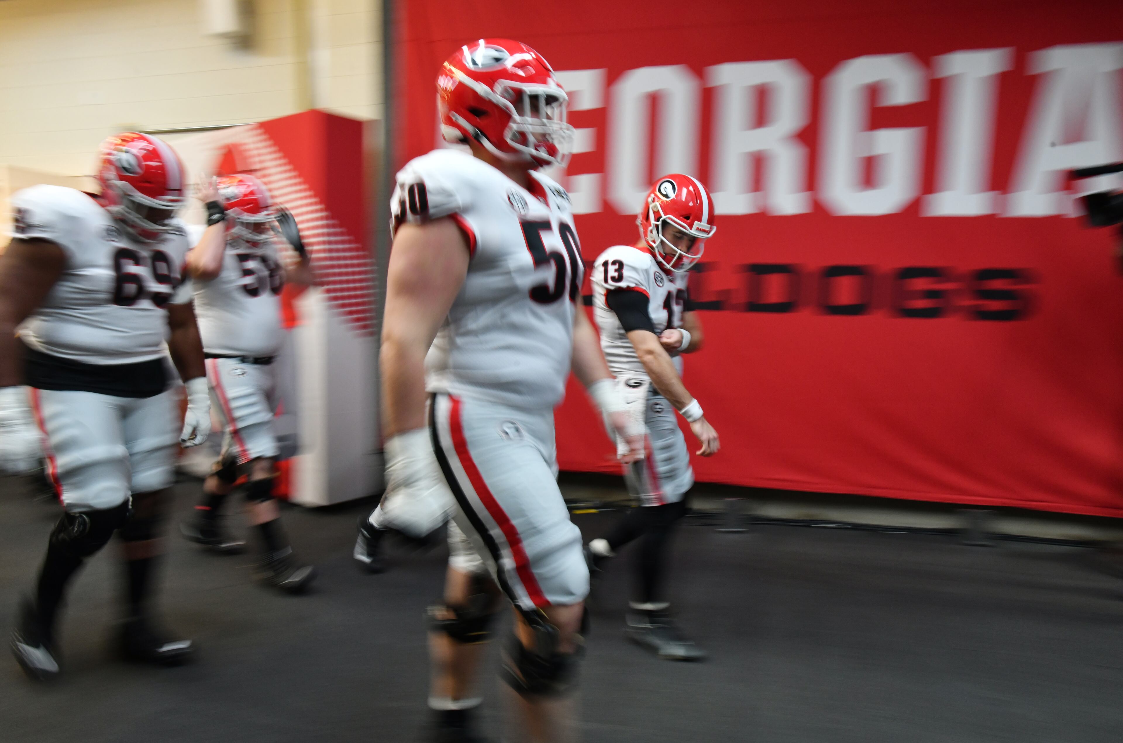 Georgia's quarterback Stetson Bennett (13) and players walk to the football field prior to the 2022 College Football Playoff National Championship Game against Alabama at Lucas Oil Stadium in Indianapolis on Monday, January 10, 2022. (Hyosub Shin / Hyosub.Shin@ajc.com)