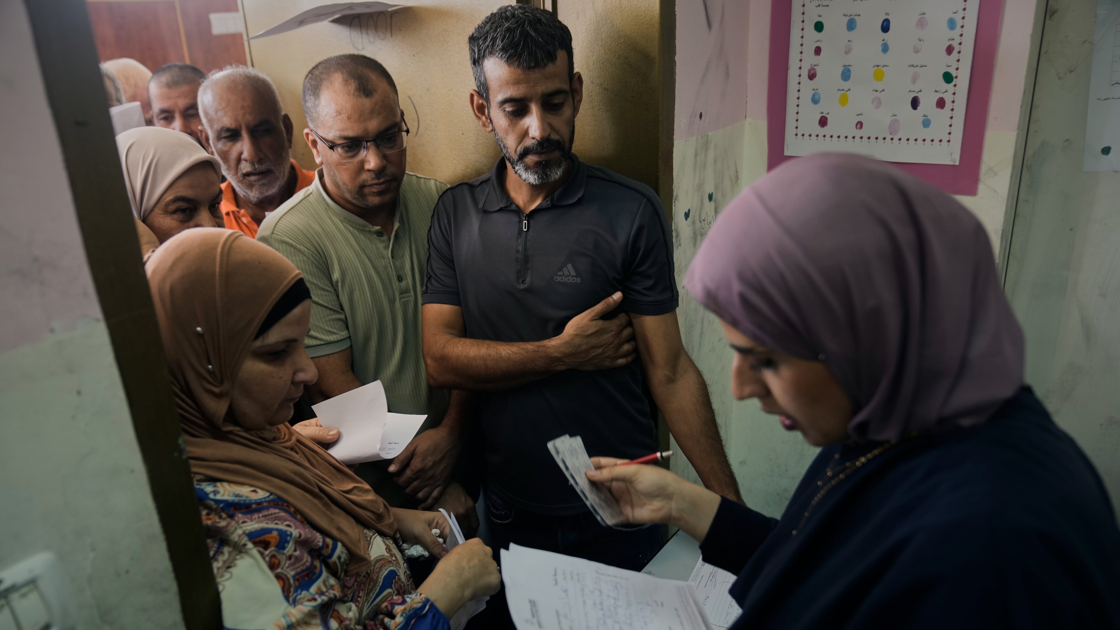 Palestinian patients line up for treatment at a mobile health clinic operated by Physicians for Human Rights Israel (PHRI) in the West Bank town of Iktaba, Tuesday, Aug. 4, 2026. (AP Photo/Majdi Mohammed)