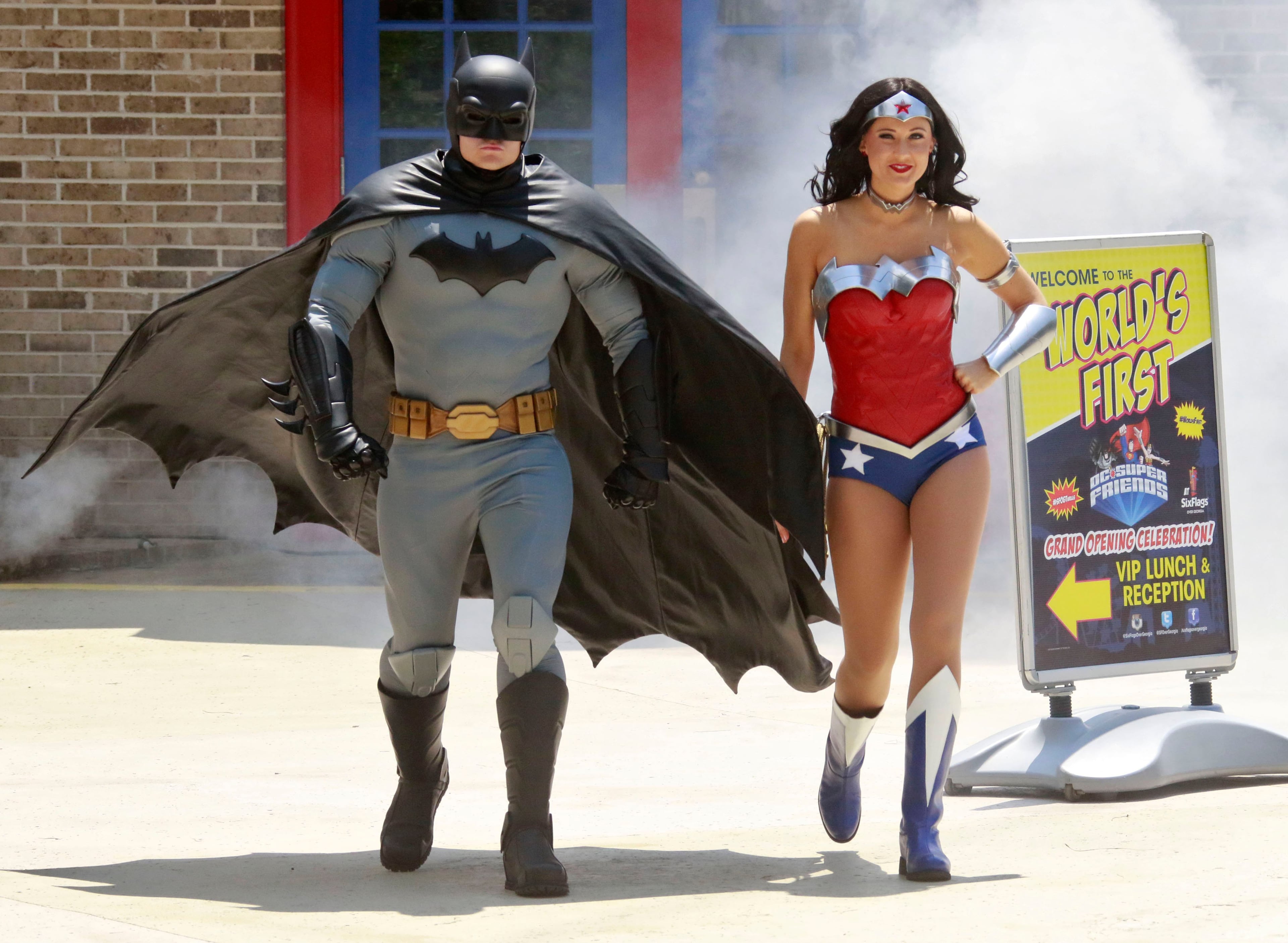 May 26, 2016, Austell — Batman and Wonder Woman enter through a cloud of fog at the start of the official opening ceremony for Six Flags Over Georgia's new DC Super Friends area. BOB ANDRES / BANDRES@AJC.COM