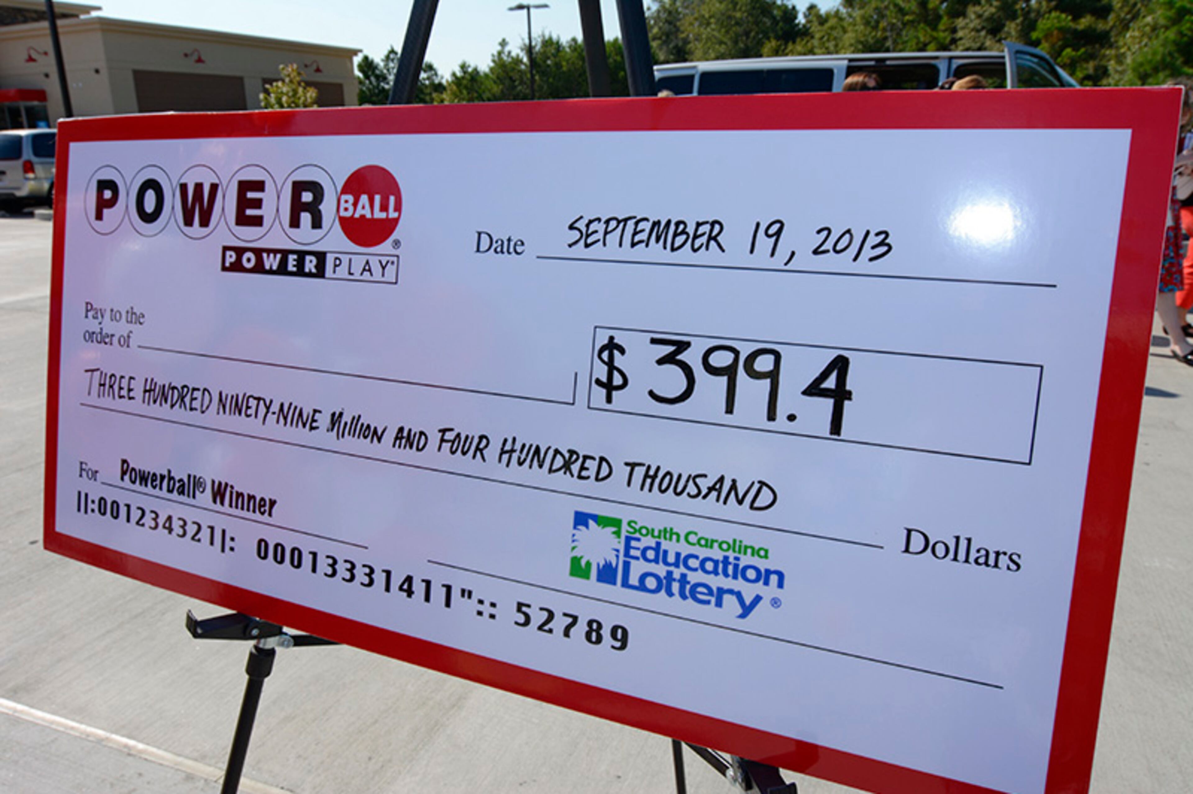 A giant check is displayed announcing a winner in the Powerball outside Murphy Express store on Thursday, Sept. 19, 2013 in Lexington, S.C. A $399.4 million winning Powerball ticket was sold at the service station just off I-20 west of Columbia. The single-ticket winner has remained anonymous as winners in South Carolina do not have to come forward publicly.