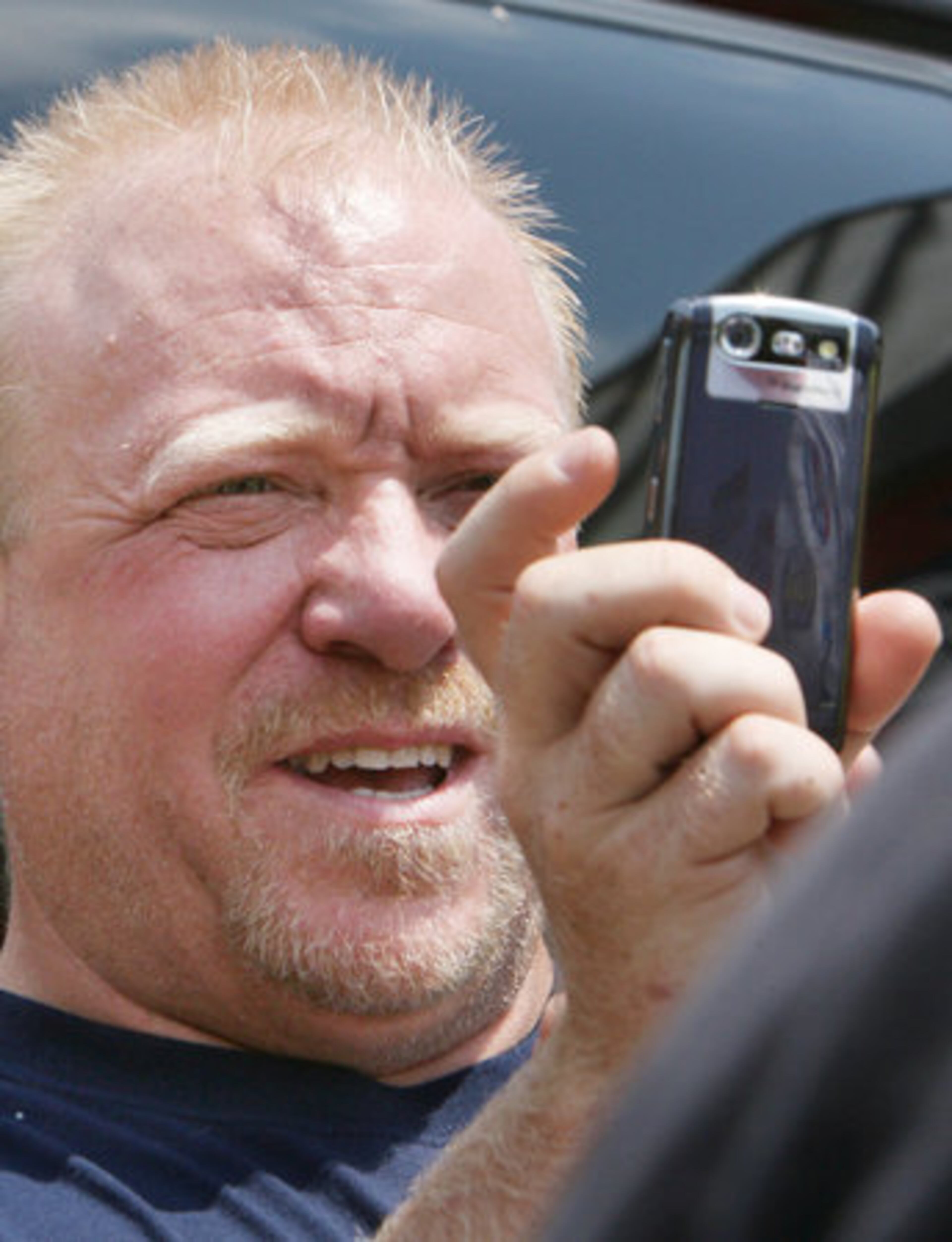 Racing fan Tim DeYoung of Jefferson uses his camera phone to take a photo of the bikers.