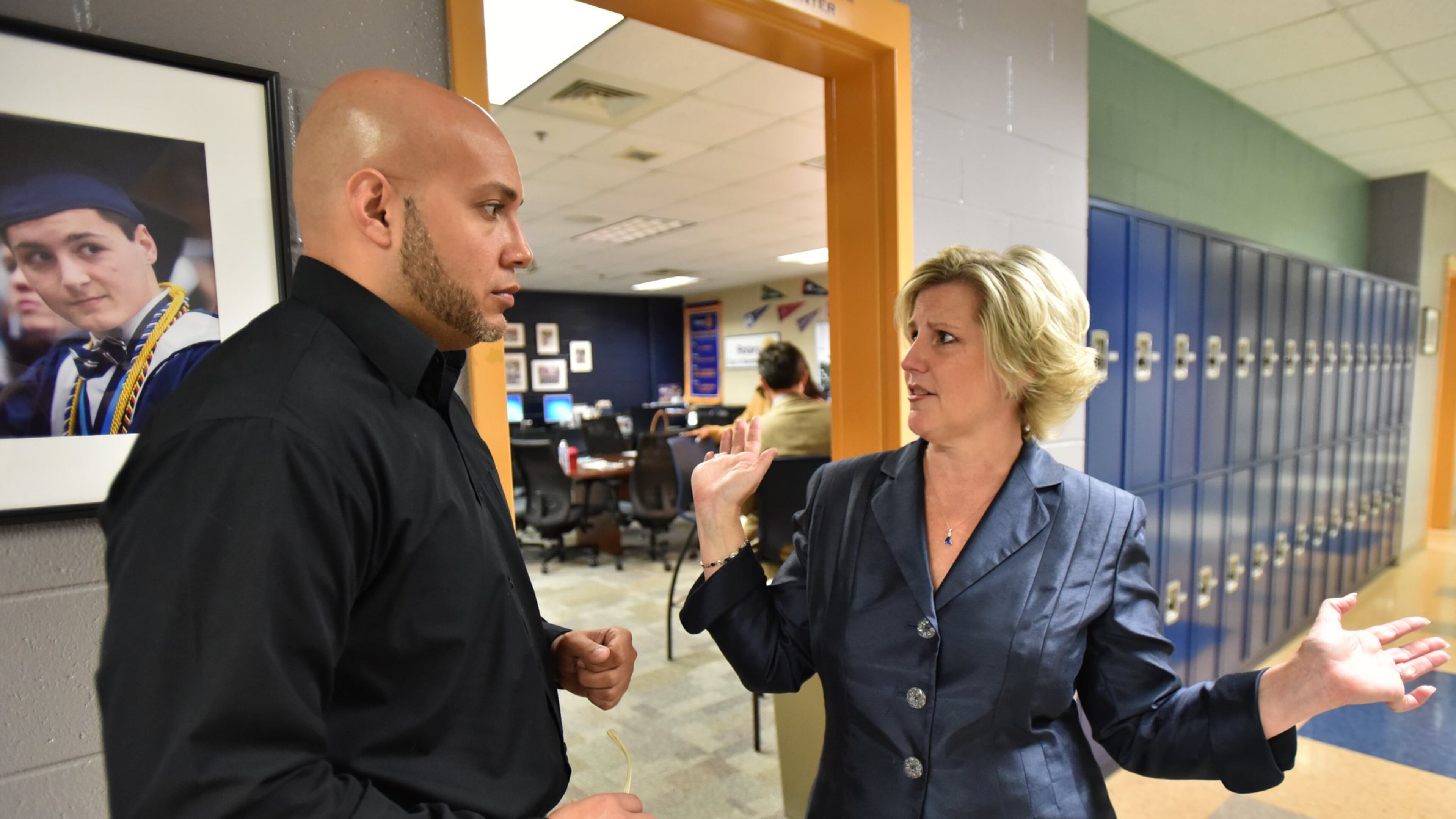 April 20, 2017 Marietta - Leigh Colburn (right), director of the Graduate Marietta Student Success Center, talks to Jose Mena, student behavior program specialist from Fulton County Schools, at the Graduate Marietta Student Success Center in Marietta High School on Thursday, April 20, 2017. Leigh Colburn has earned plaudits for her work with at-risk students at the 2-year-old Graduate Marietta Student Success Center, an experiment housed inside the city’s high school. Educators from across Georgia have made pilgrimages to the center, hoping to find ideas they can copy. HYOSUB SHIN / HSHIN@AJC.COM
