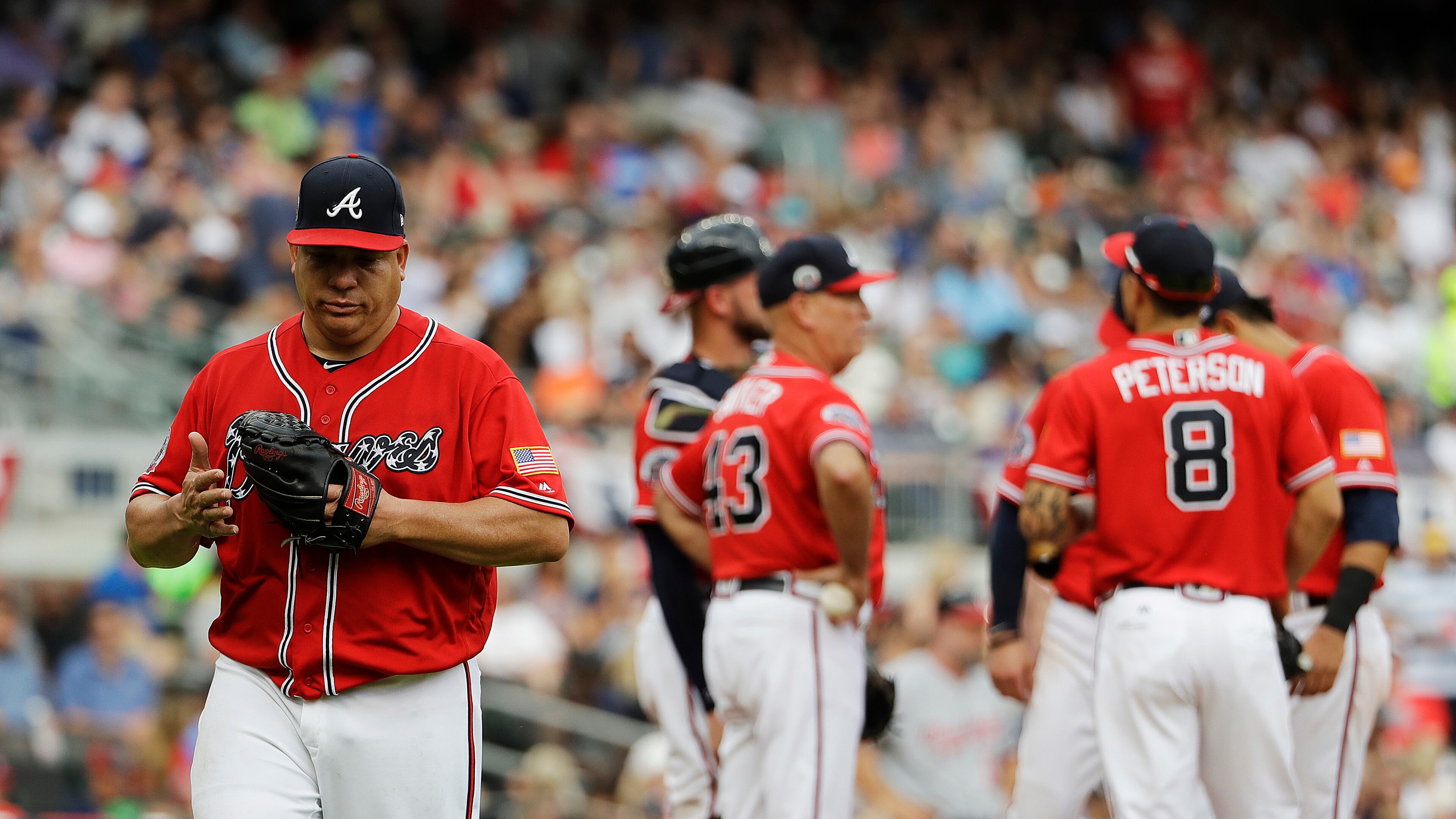 Atlanta Braves starting pitcher Bartolo Colon, left, is relieved in the fifth inning of a baseball game against the Washington Nationals in Atlanta, Saturday, May 20, 2017. (AP Photo/David Goldman)