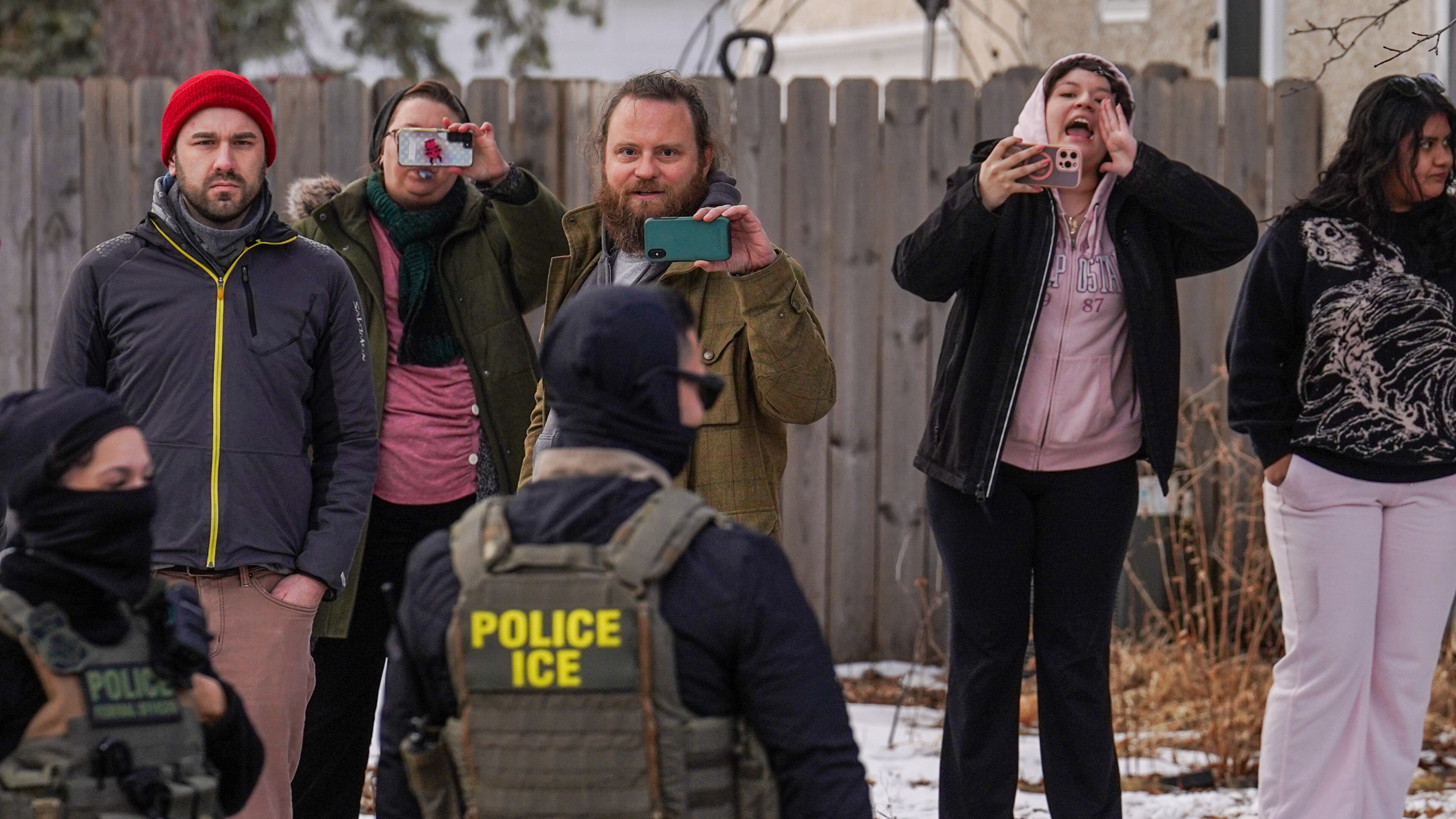 Observers film while federal agents conduct immigration enforcement operations, on Thursday, Feb. 5, 2026, in Minneapolis. (AP Photo/Ryan Murphy)