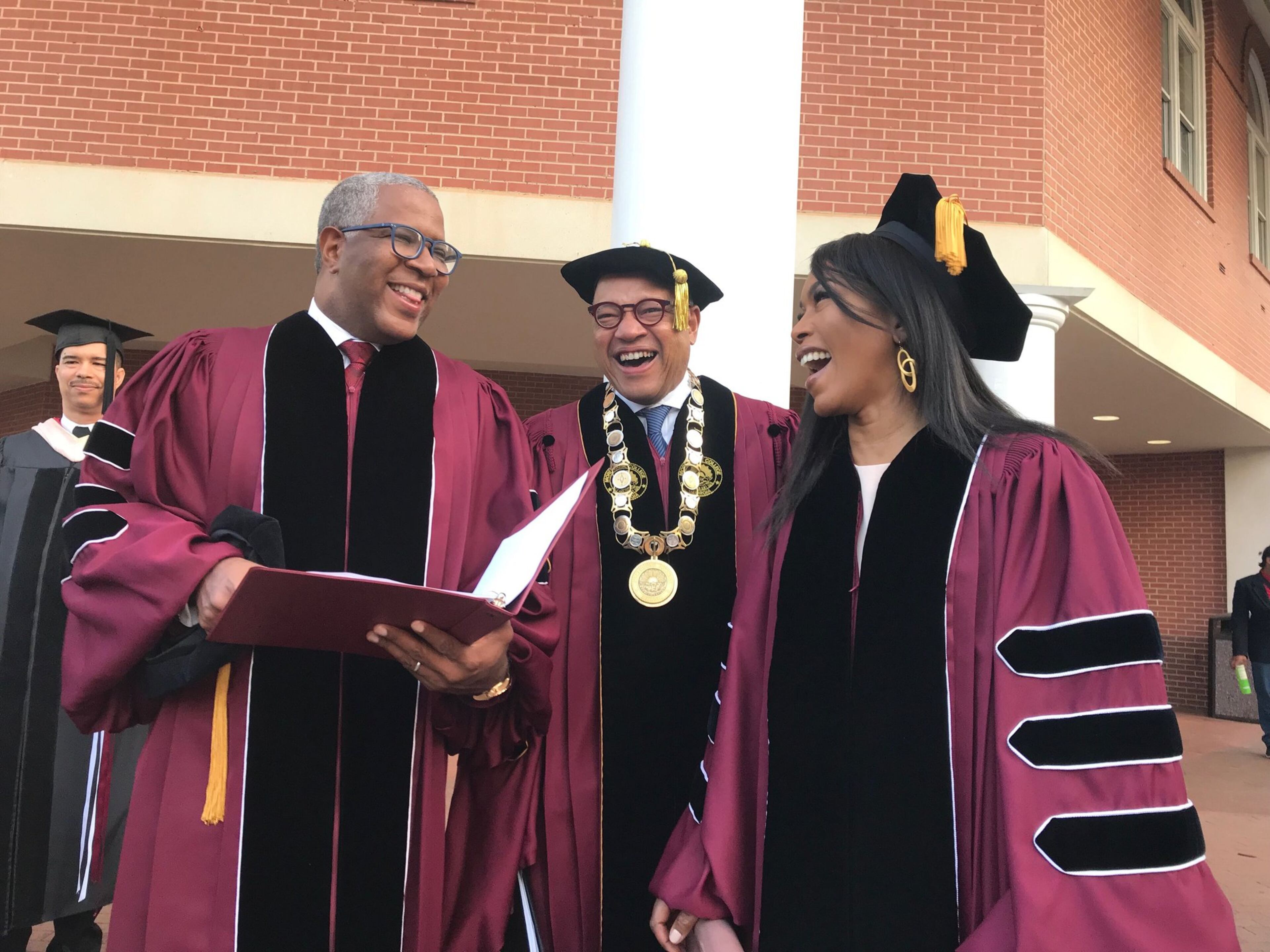 Tech billionaire Robert F. Smith, Morehouse College President David Thomas and actress Angela Bassett prepare to walk to the graduation ceremonies at the college in May. Smith and Bassett received honorary degrees.