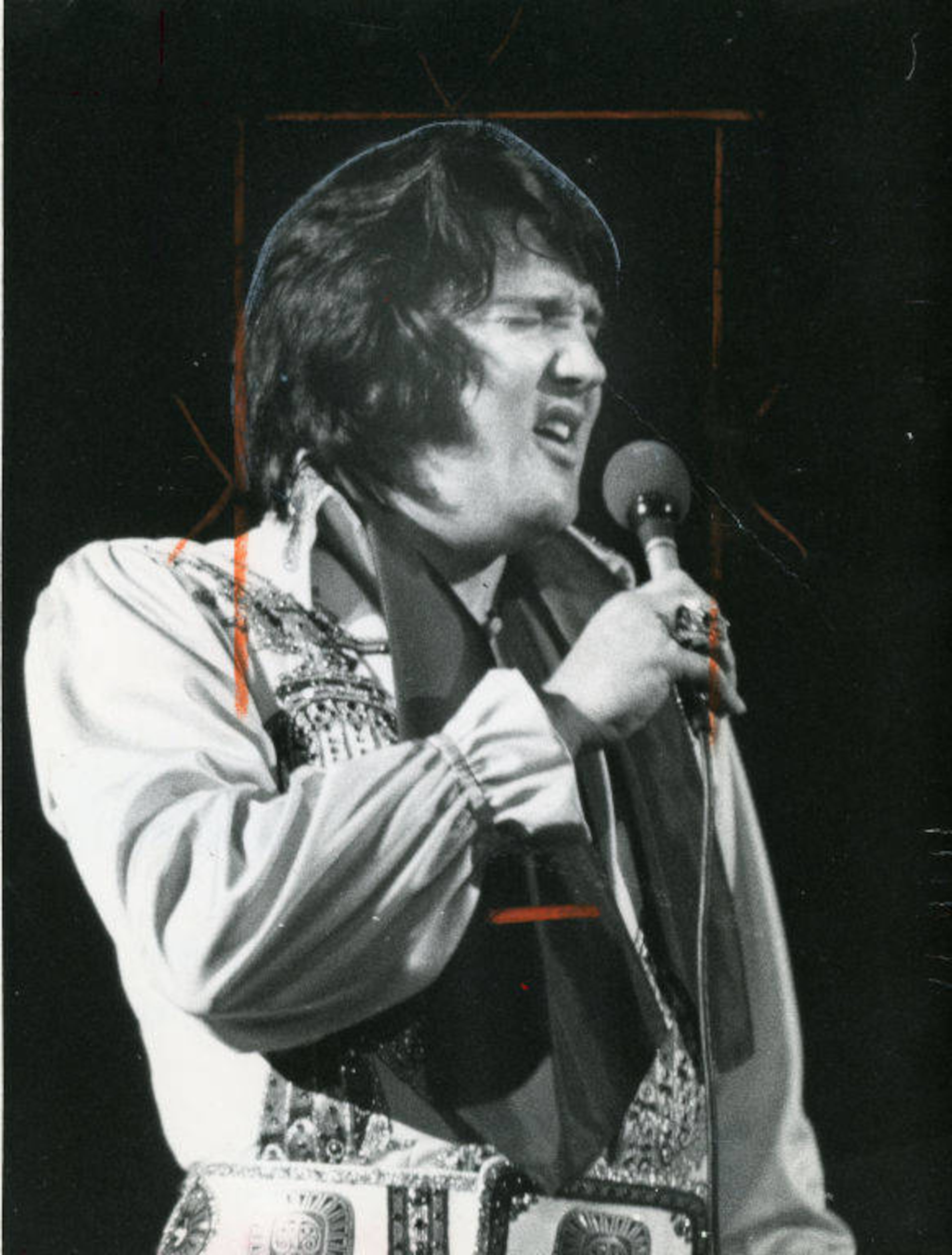 Elvis Presley, holding a microphone, performing at the Omni in Atlanta on June 4, 1976. Joe McTyre/AJC