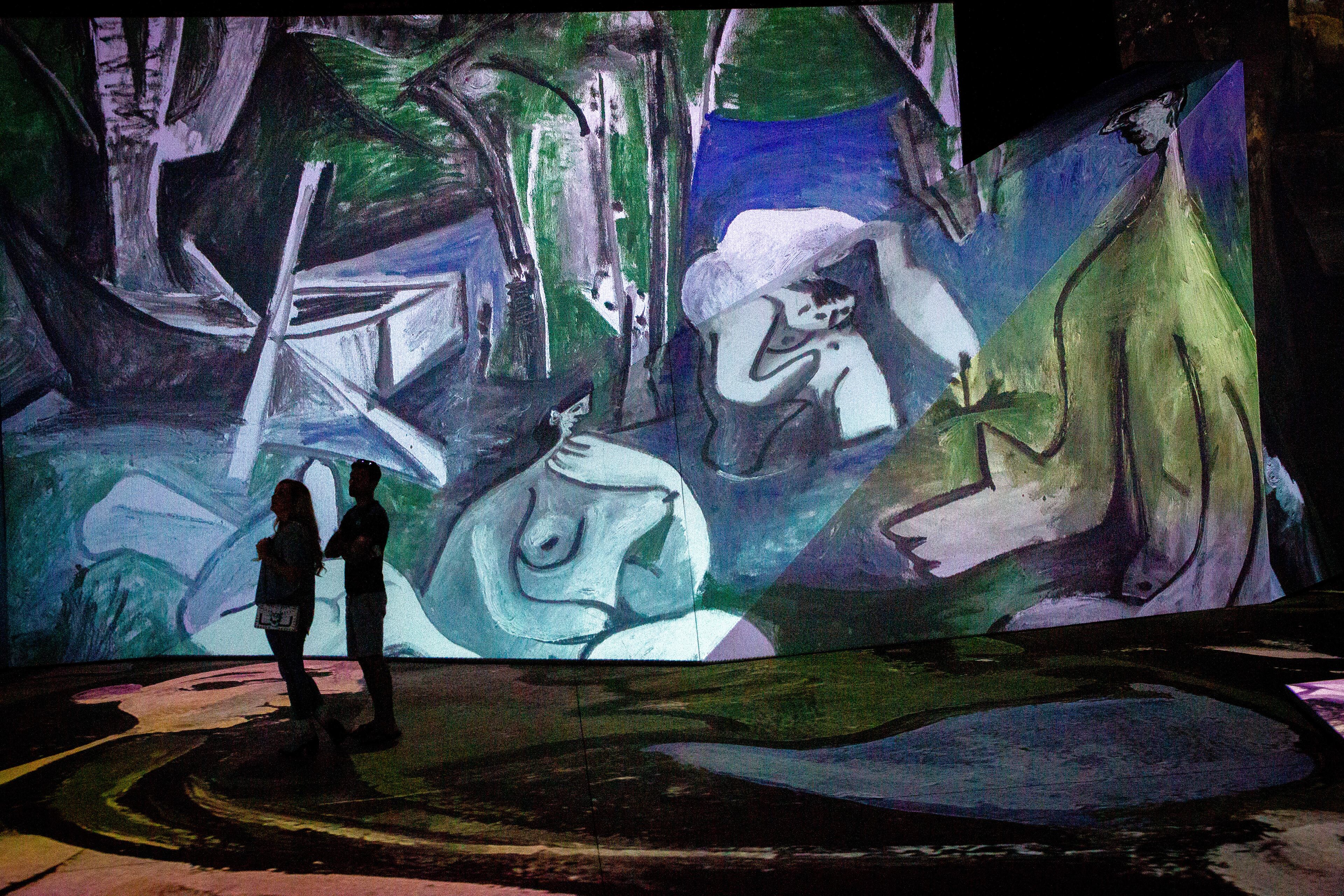 People look over the Imagine Picasso Atlanta: Immersive Art Exhibition on opening day at Pullman Yards in Atlanta Thursday, 17 2022. STEVE SCHAEFER FOR THE ATLANTA JOURNAL-CONSTITUTION