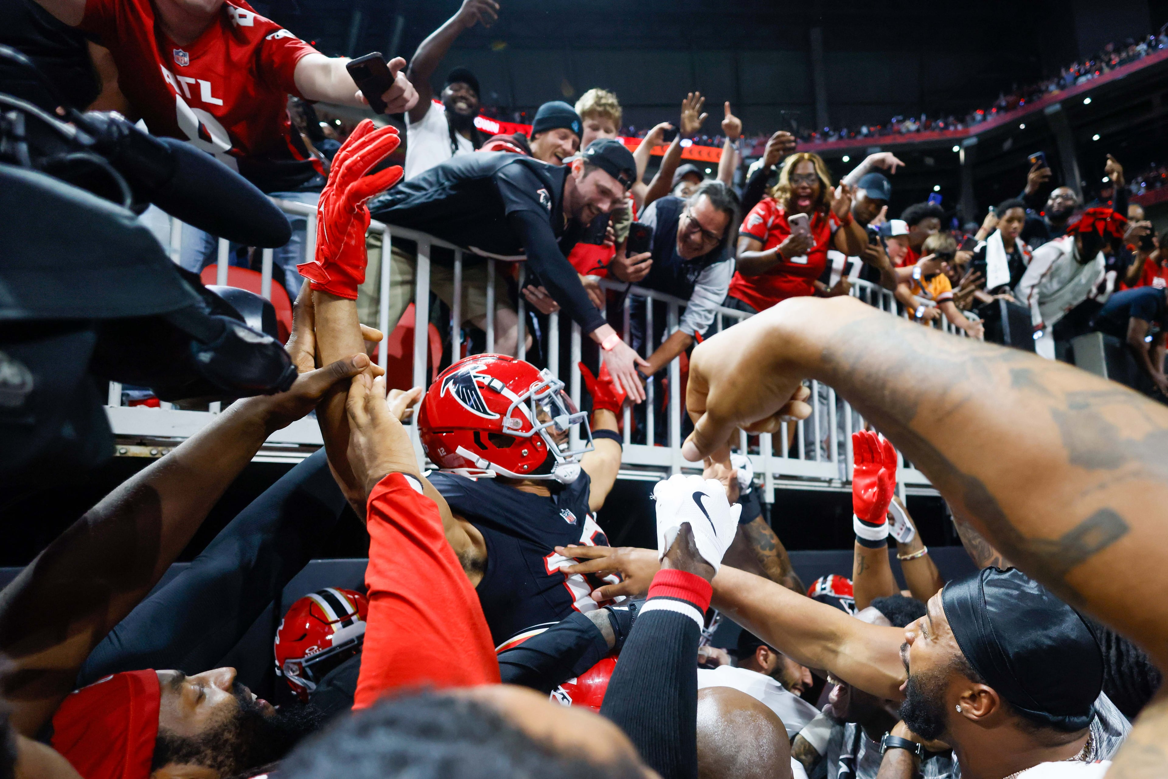 Atlanta Falcons wide receiver KhaDarel Hodge (12) gets carried by teammates after scoring the game-winning touchdown in overtime.
(Miguel Martinez/ AJC)
