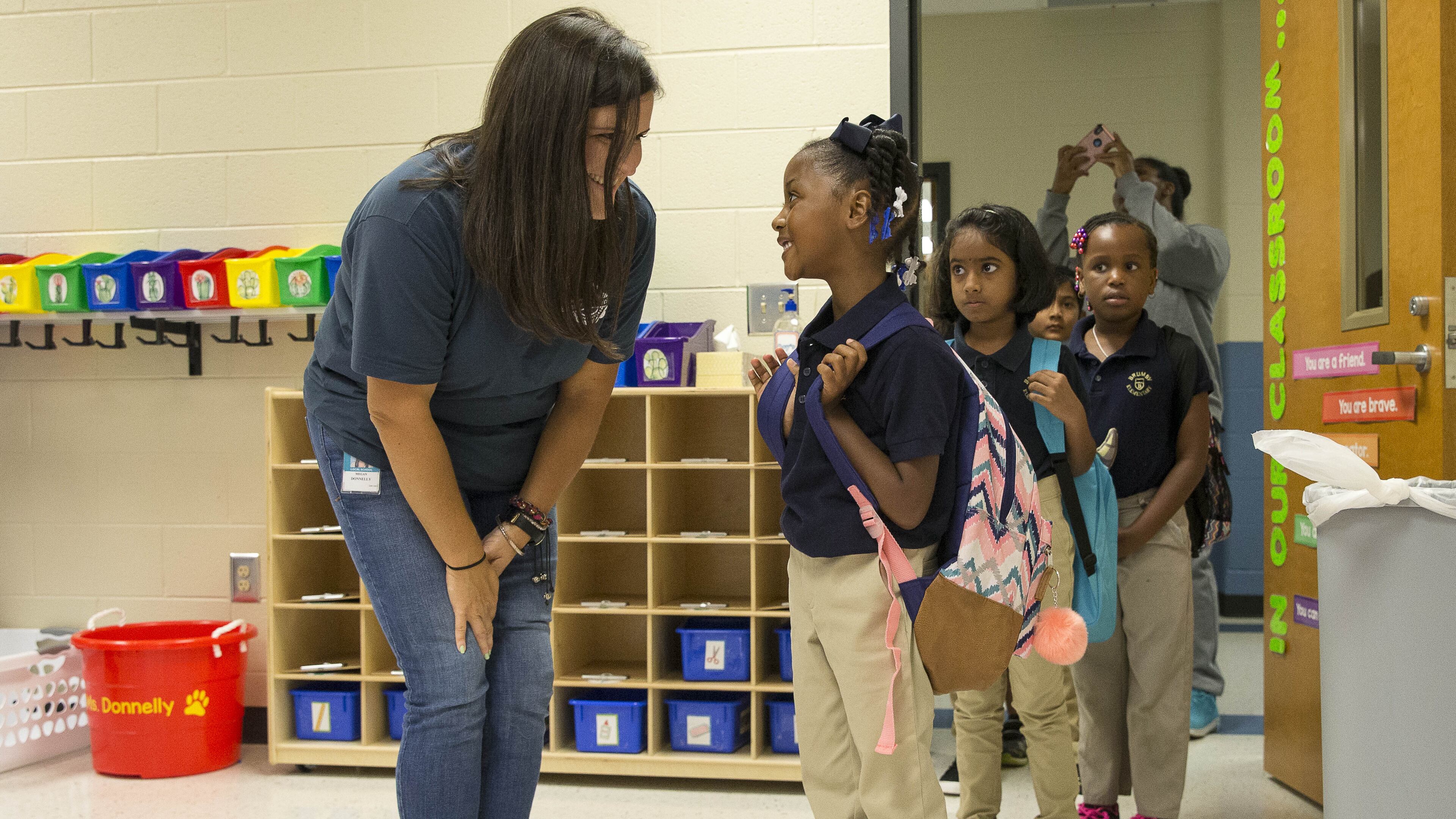 Second grade teacher Megan Donnelly greets Aniya Bowden during the first day of school at Brumby Elementary School in Marietta last month. A House member says Georgia must do more to attract and keep teachers in the classroom.