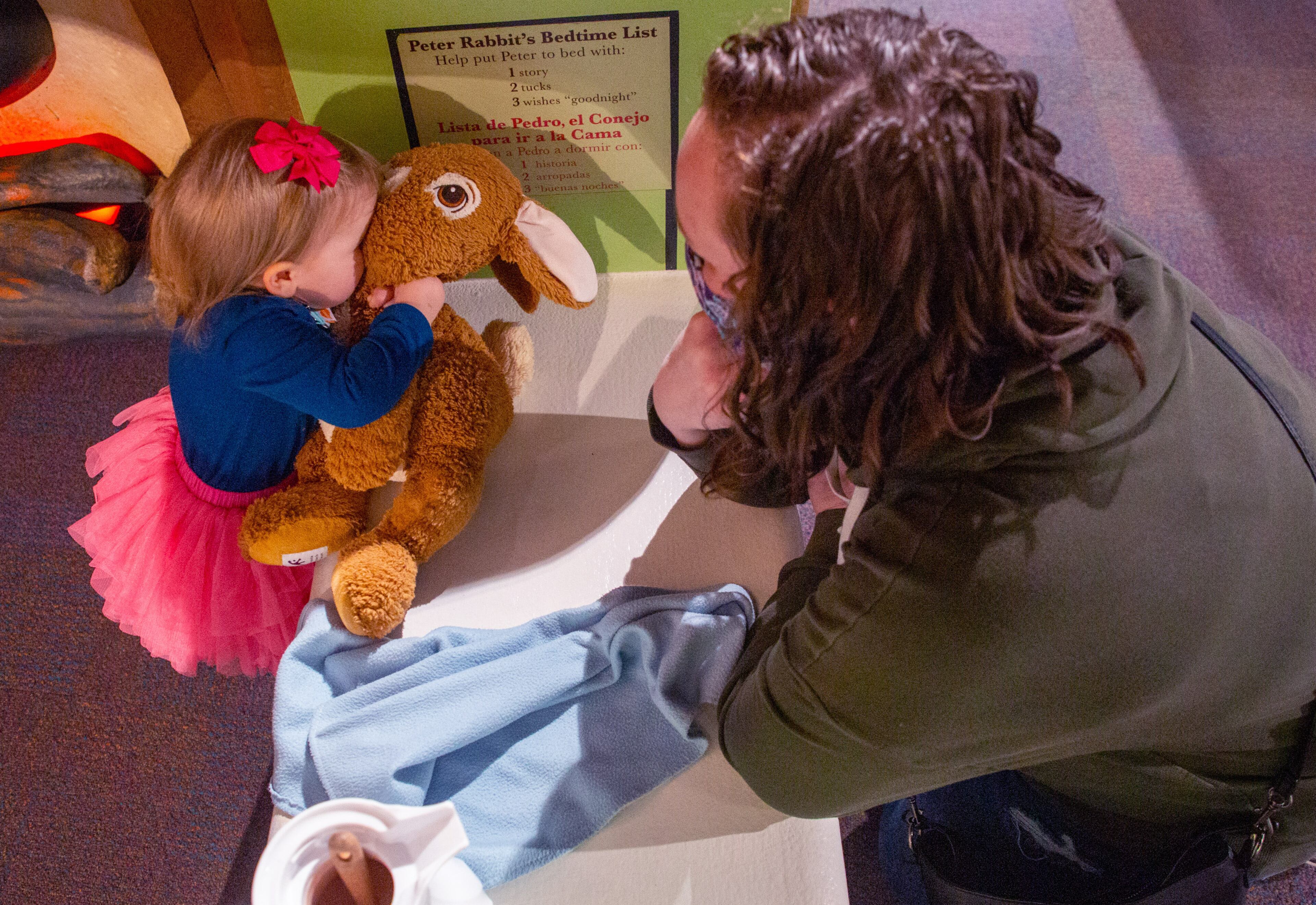 Stella Haston, 1, kisses a stuffed Peter Rabbit while at the Children's Museum of Atlanta at the book-based experience/exhibit on Saturday, February 5, 2022. "Storyland: A Trip Through Childhood Favorites" continues through May 30. (Photo: Steve Schaefer for The Atlanta Journal-Constitution)