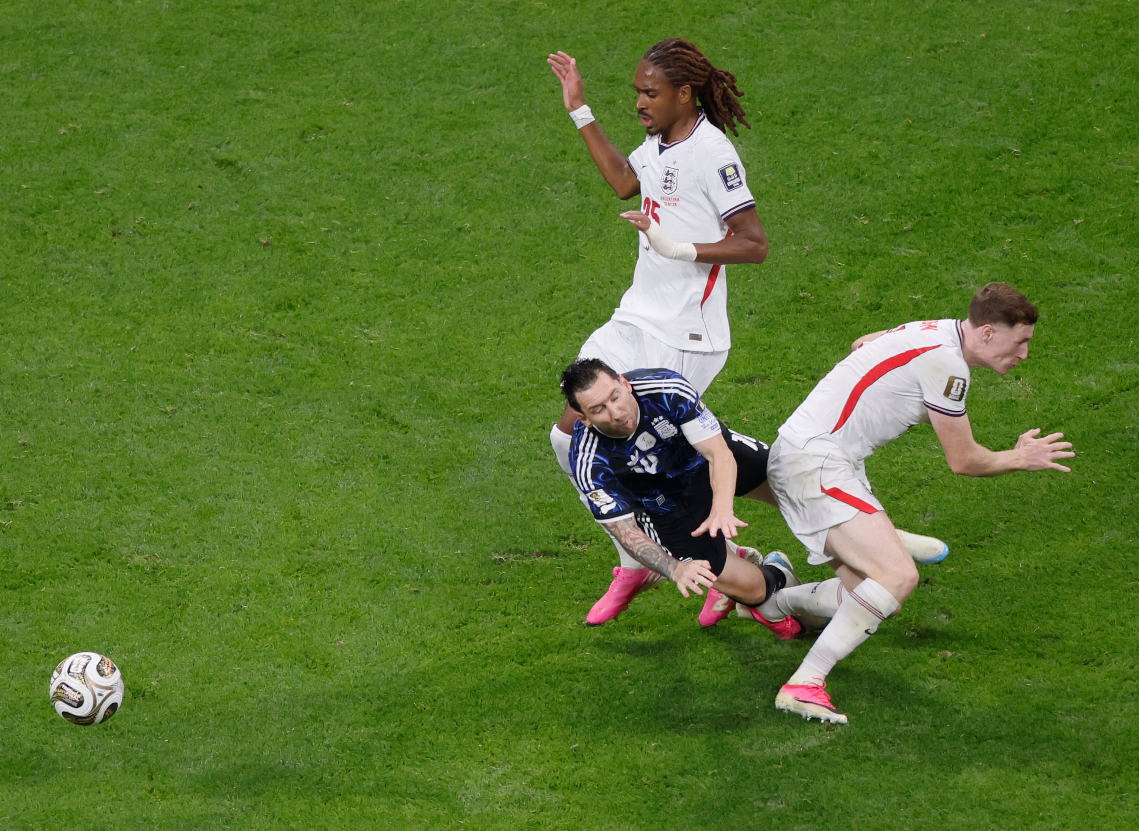 England's Elliot Anderson, right, fouls Argentina's Lionel Messi and receives a yellow card during first half of Argentina vs. England FIFA World Cup Semifinal match at Atlanta Stadium (Mercedes-Benz Stadium) on Wednesday, July 15, 2026. (Miguel Martinez/AJC)
