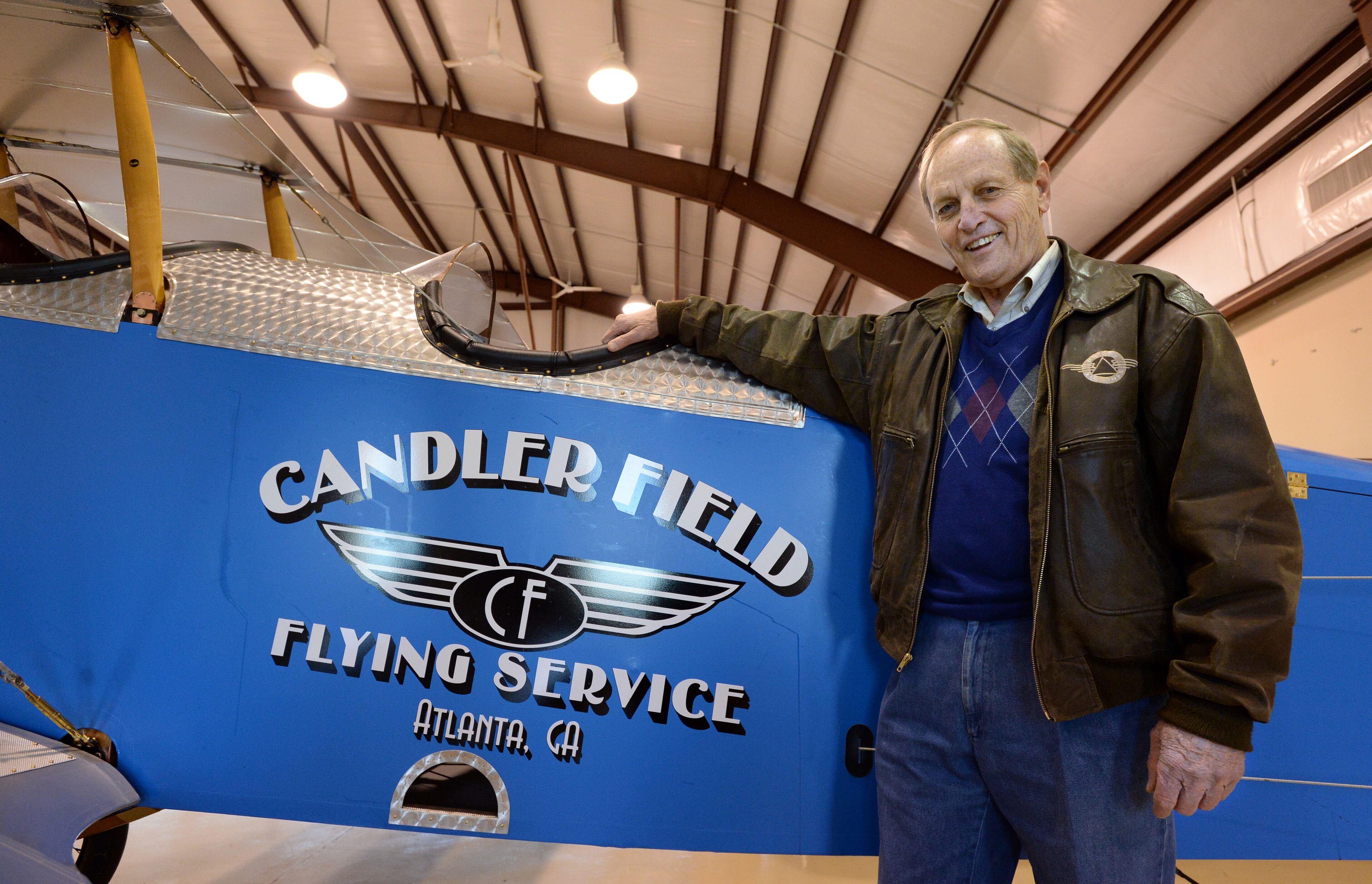 Candler Field Museum Director Ron Alexander poses in front of Curtiss JN-4 'Jenny' at the Candler Field Museum in Williamson on Wednesday, December 20, 2013. The airplane was manufactured in 1917 and was just completely restored. It is the same type airplane that Charles Lindbergh learned to fly in. The airplane flies on a regular basis. The Candler Field Museum was established to recreate the old Atlanta airport as it existed in the 1920's and 1930's. HYOSUB SHIN / HSHIN@AJC.COM