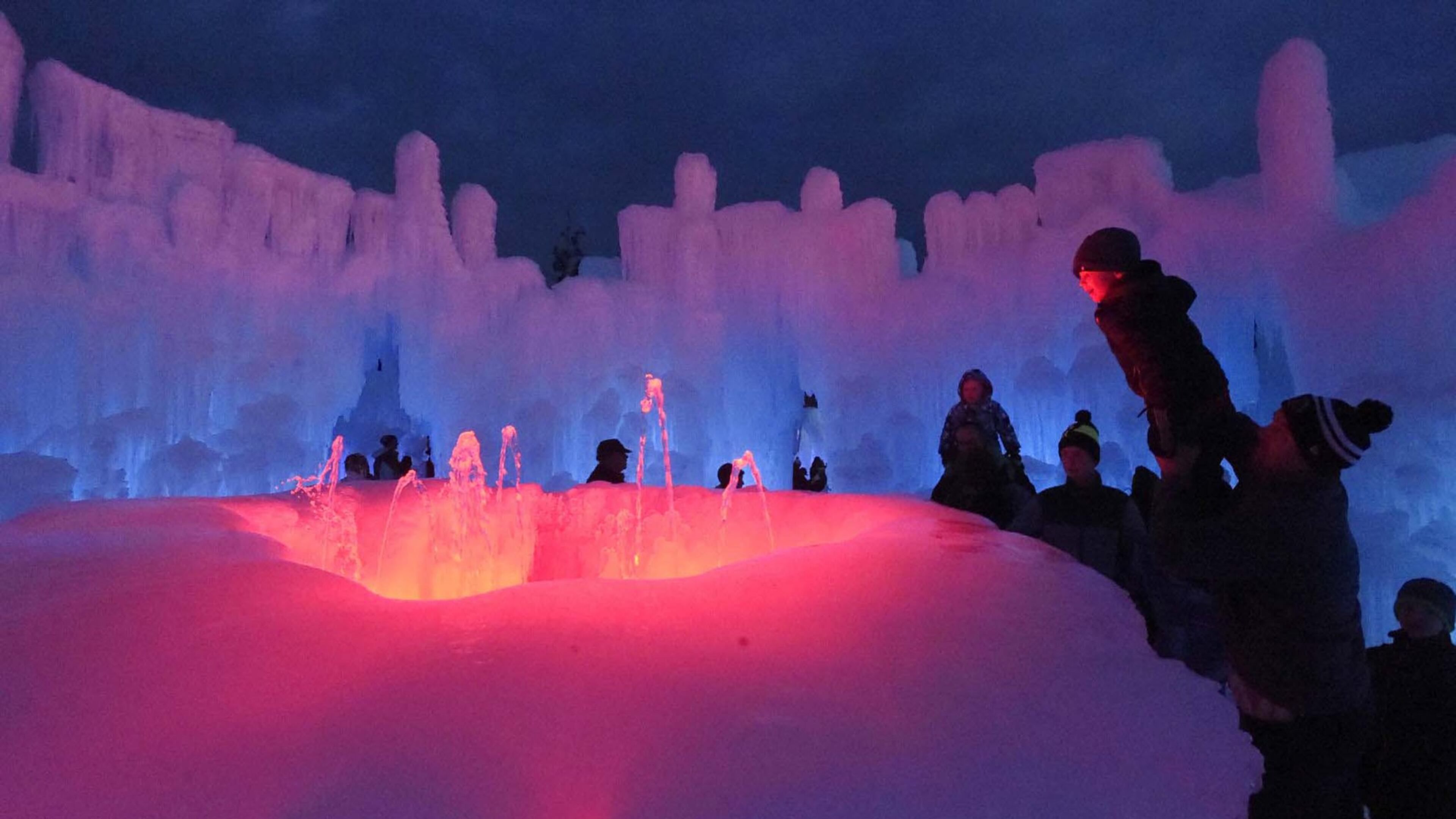 A fountain is one of the most popular features for visitors to the Dillon Ice Castles. Tate Shellenberger gets a lift from his dad, Ryan Shellenberger, to look into the lit fountain on Friday, January 5, 2018. Ice Castles is a Utah-based entertainment company that specializes in large-scale events handcrafted from ice. (Jerilee Bennett/Colorado Springs Gazette/TNS)