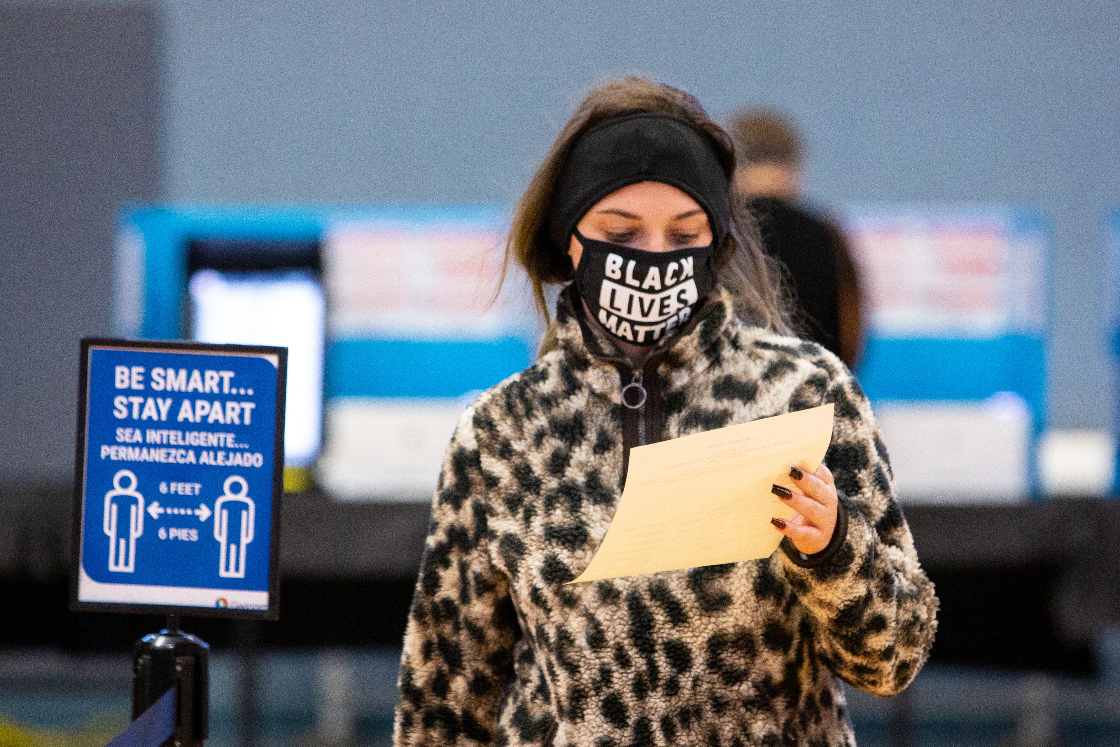 A voter with a Black Lives Matter mask reviews her ballot before dropping it off at Lucky Shoals Park Community Recreation Center in Norcross, Ga., on Tuesday, Nov. 3, 2020. (Casey Sykes for The Atlanta-Journal Constitution)
