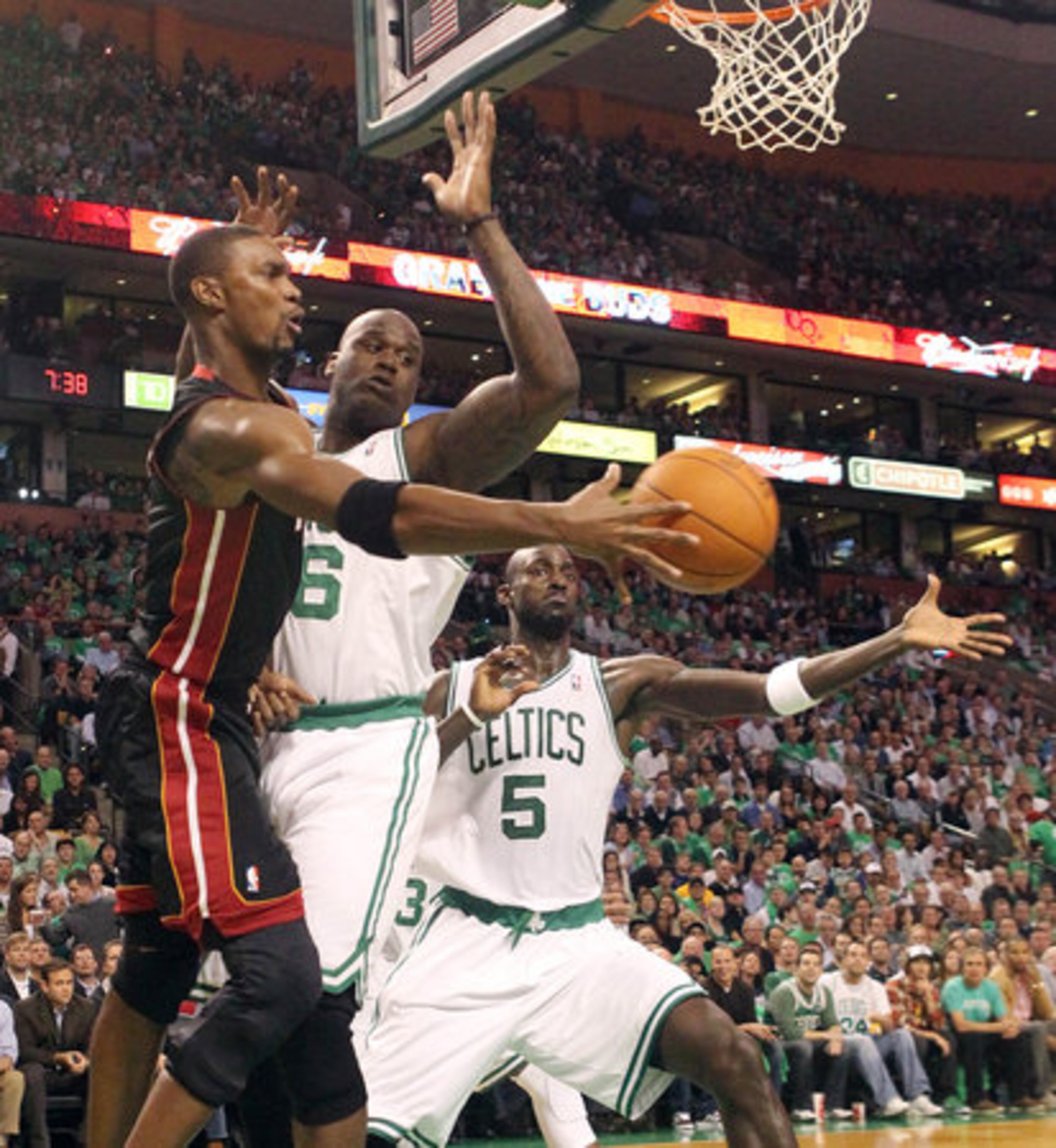 James wasn't the only Heat player making his debut. Bosh inbounds the ball past O'Neal and Kevin Garnett.