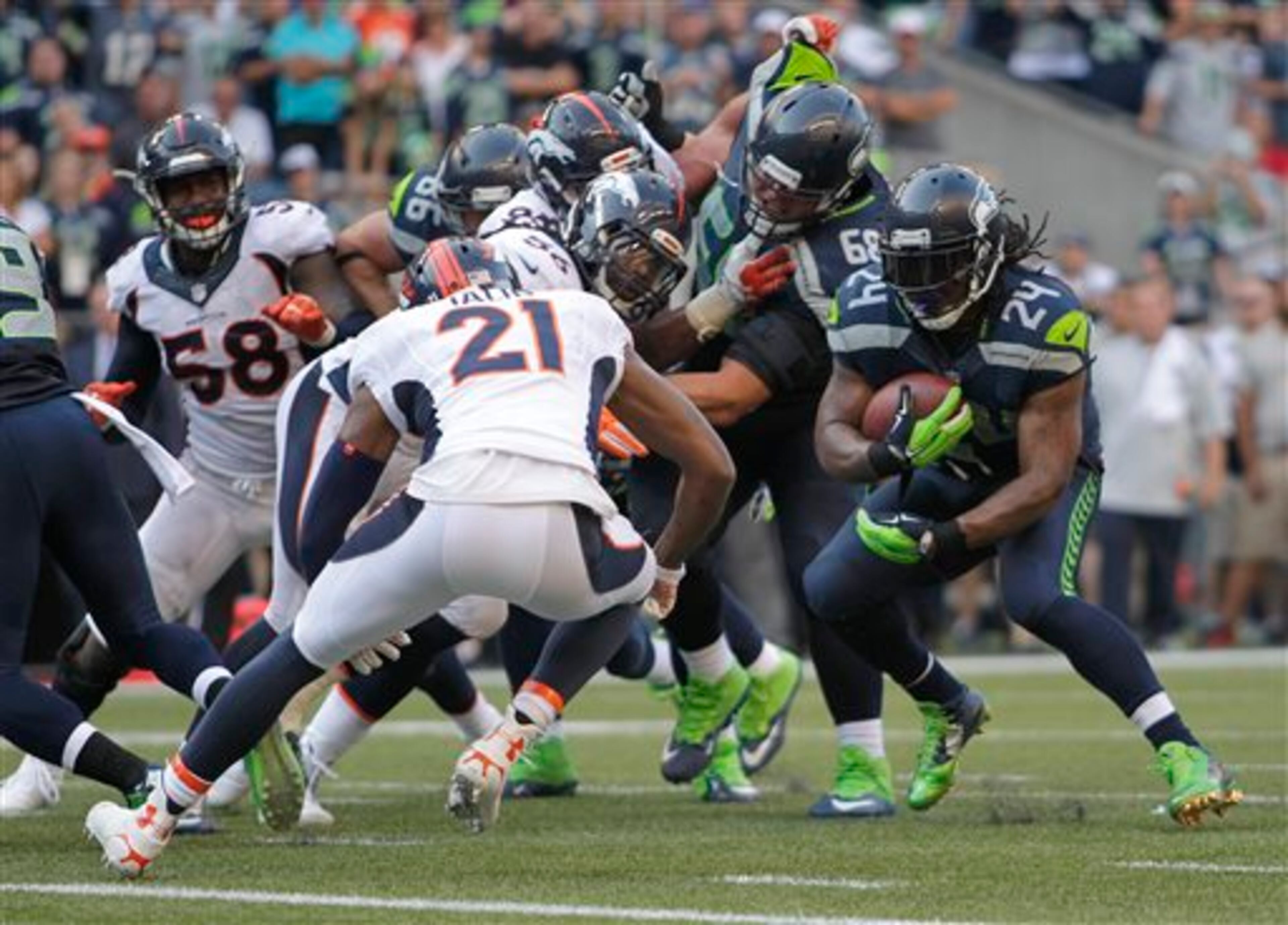 Seattle Seahawks running back Marshawn Lynch (24) runs before he dove in for the game-winning touchdown in overtime of an NFL football game against the Denver Broncos, Sunday, Sept. 21, 2014, in Seattle. The Seahawks won 26-20. (AP Photo/John Froschauer)