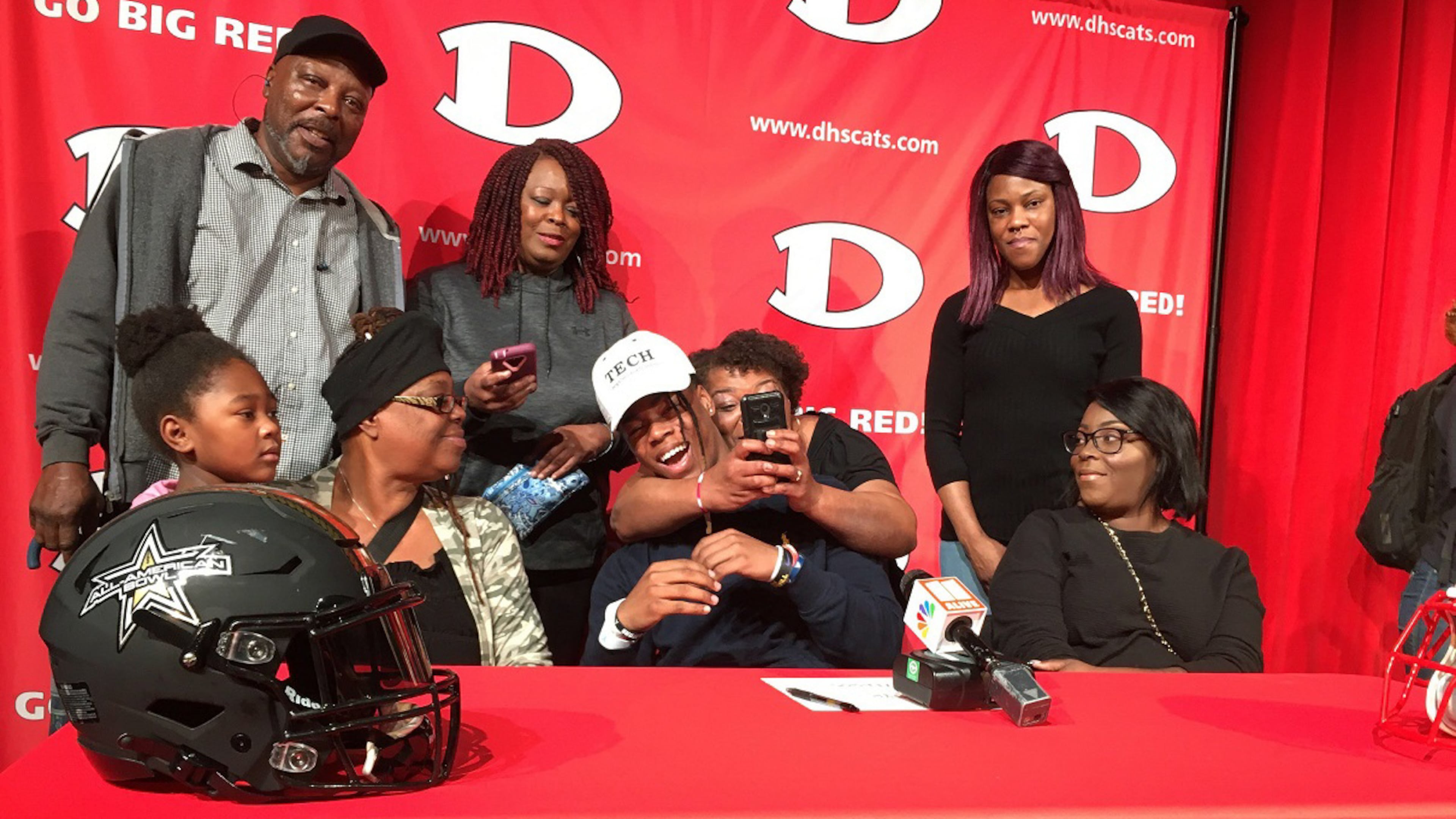 Dalton High running back Jahmyr Gibbs celebrates with family after he announced Wednesday, Feb. 5, 2020 that he will play football for the Georgia Tech Yellow Jackets. In the photo, counterclockwise from left: cousin Ah’triniti O’Neal, great uncle Daniel Wyche, aunt Carla Carmichael, great aunt Cassandra Wyche (with phone), mother Neka Willis, aunt Mia Willis, Gibbs and grandmother Angela Willis. (Photo by Ken Sugiura/AJC)