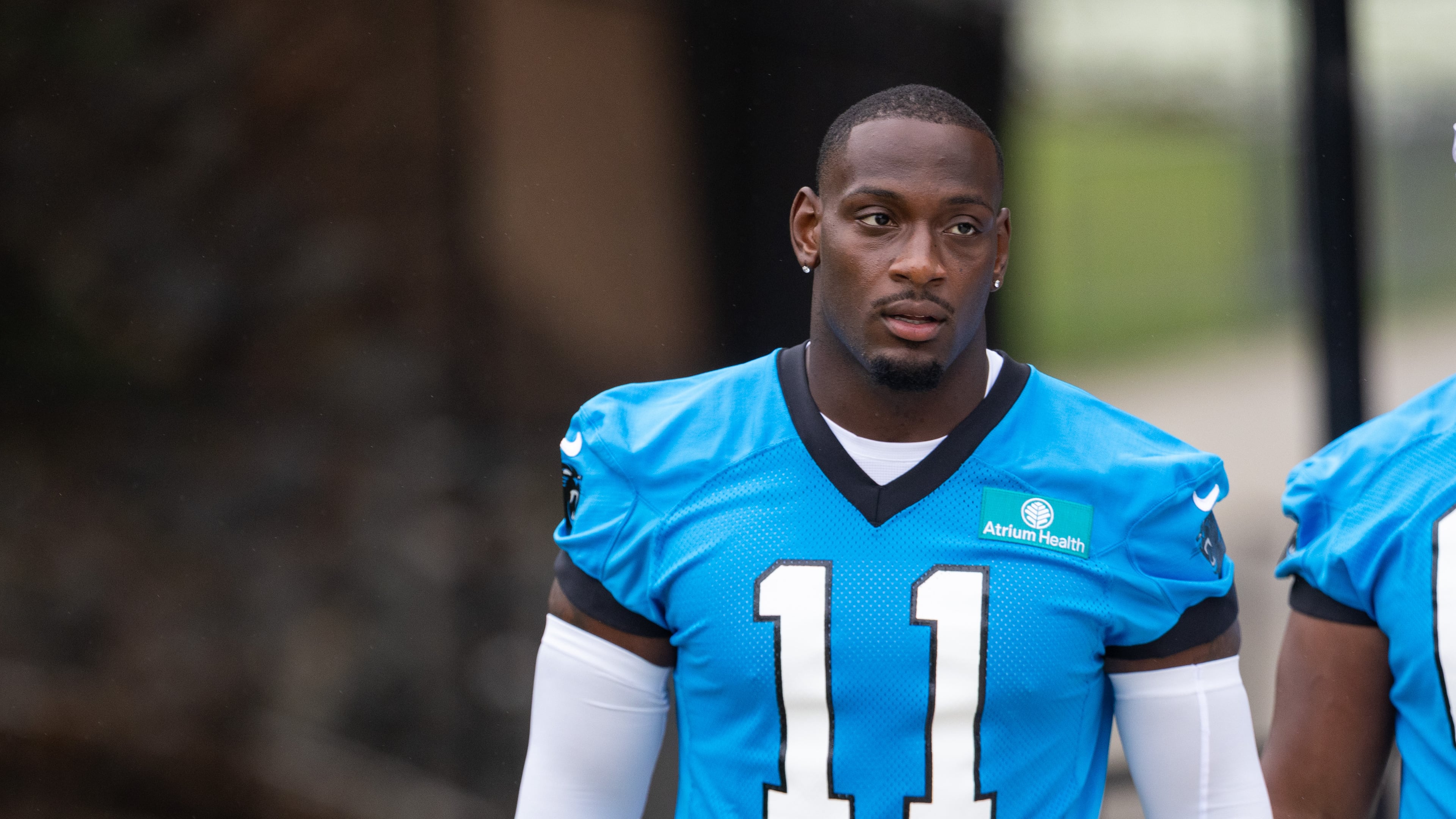 Carolina Panthers linebacker Nic Scourton (11) walks to the NFL football team's training camp Thursday, July 23, 2026, in Charlotte, N.C. (AP Photo/Scott Kinser)