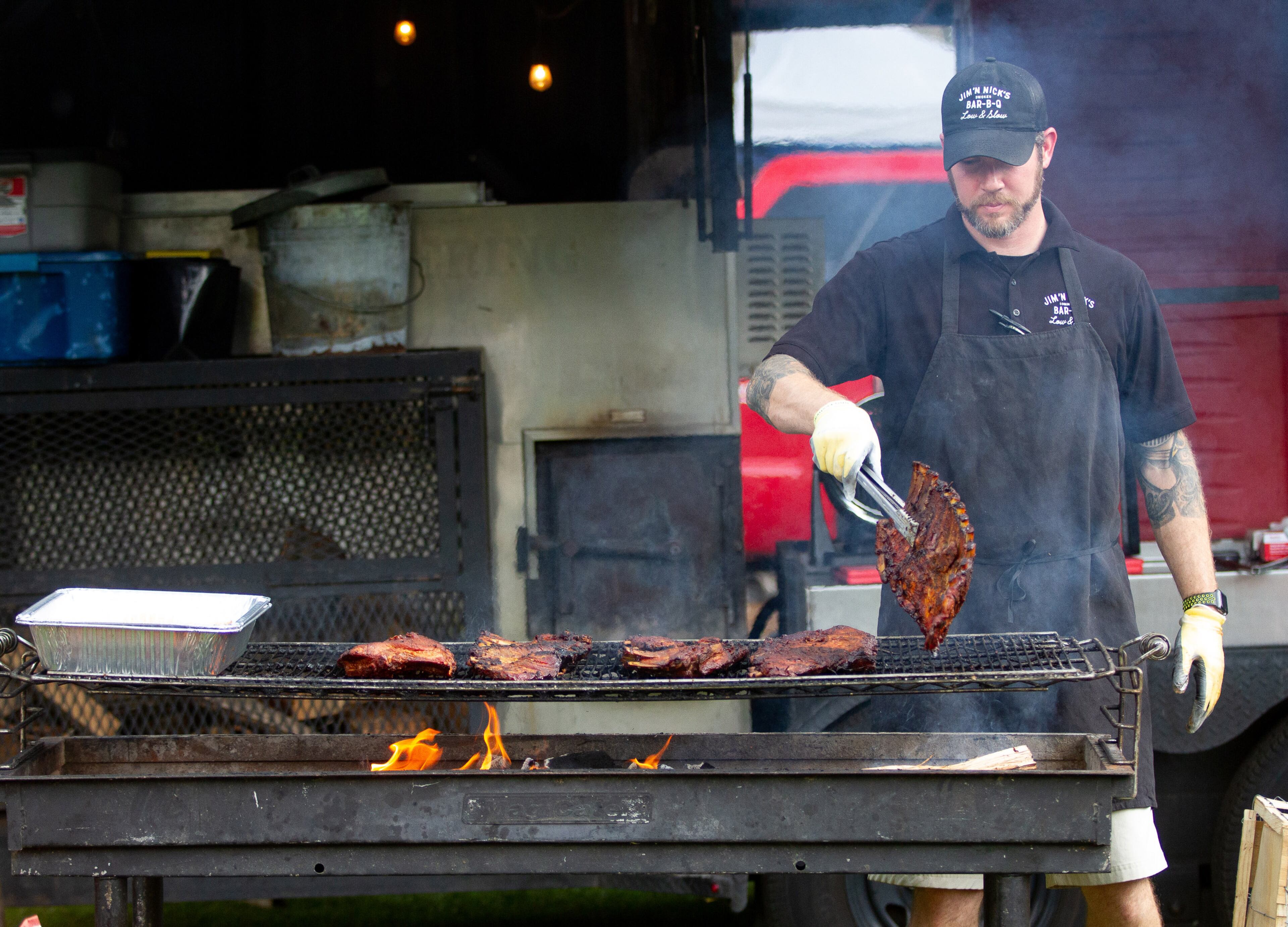 Warren Coleman from Jim'N Nick's Bar-B-Q puts the final touches on some ribs at the start of the 19th annual Decatur BBQ Blues & Bluegrass festival on Saturday, August 10, 2019. STEVE SCHAEFER / SPECIAL TO THE AJC