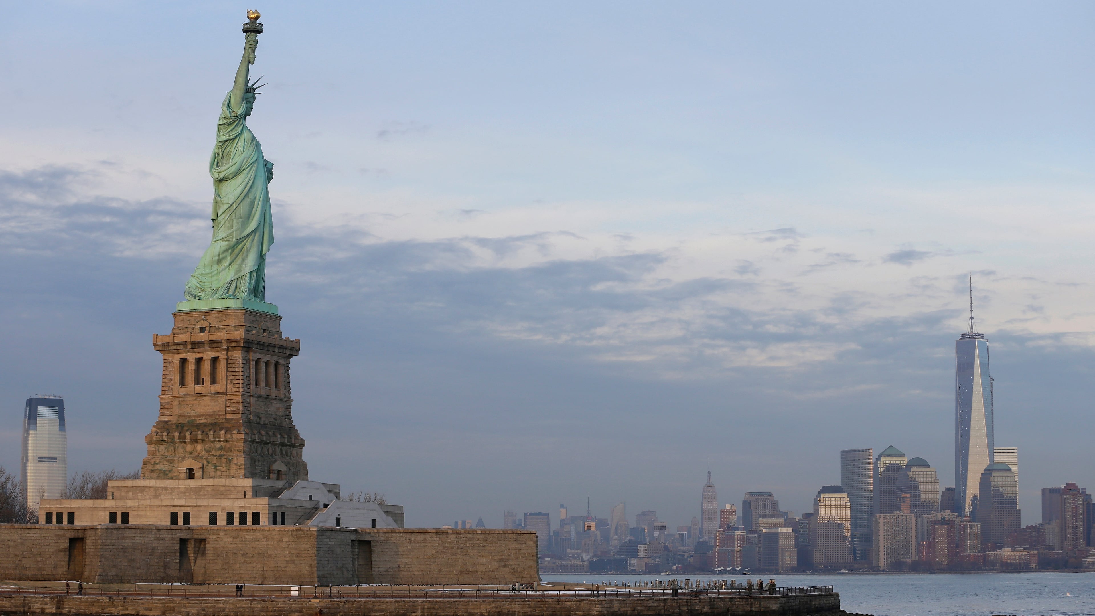 FILE - The lower Manhattan skyline, including the new One World Trade Center building at right, is shown as viewed from near the Statue of Liberty, Jan. 31, 2014, in New York. (AP Photo/Ted S. Warren, File)