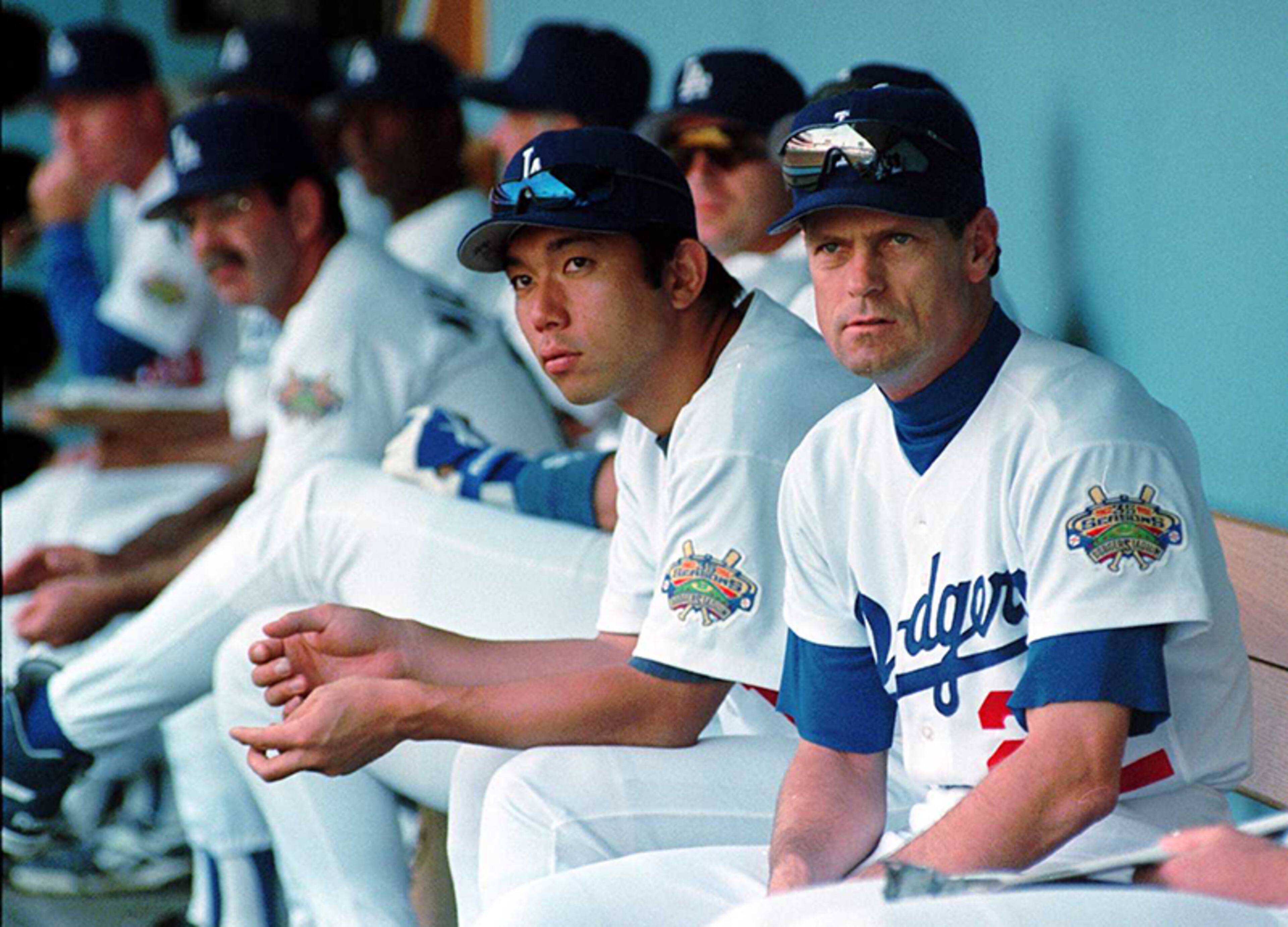 Los Angeles Dodgers pitcher Hideo Nomo (second from right) and outfielder Brett Butler watch the action from the dugout during Game 1 of the National League Division Series playoffs against the Atlanta Braves, on Oct. 2, 1996, at Dodger Stadium in Los Angeles. The Braves defeated the Dodgers, 2-1, in 10 innings.