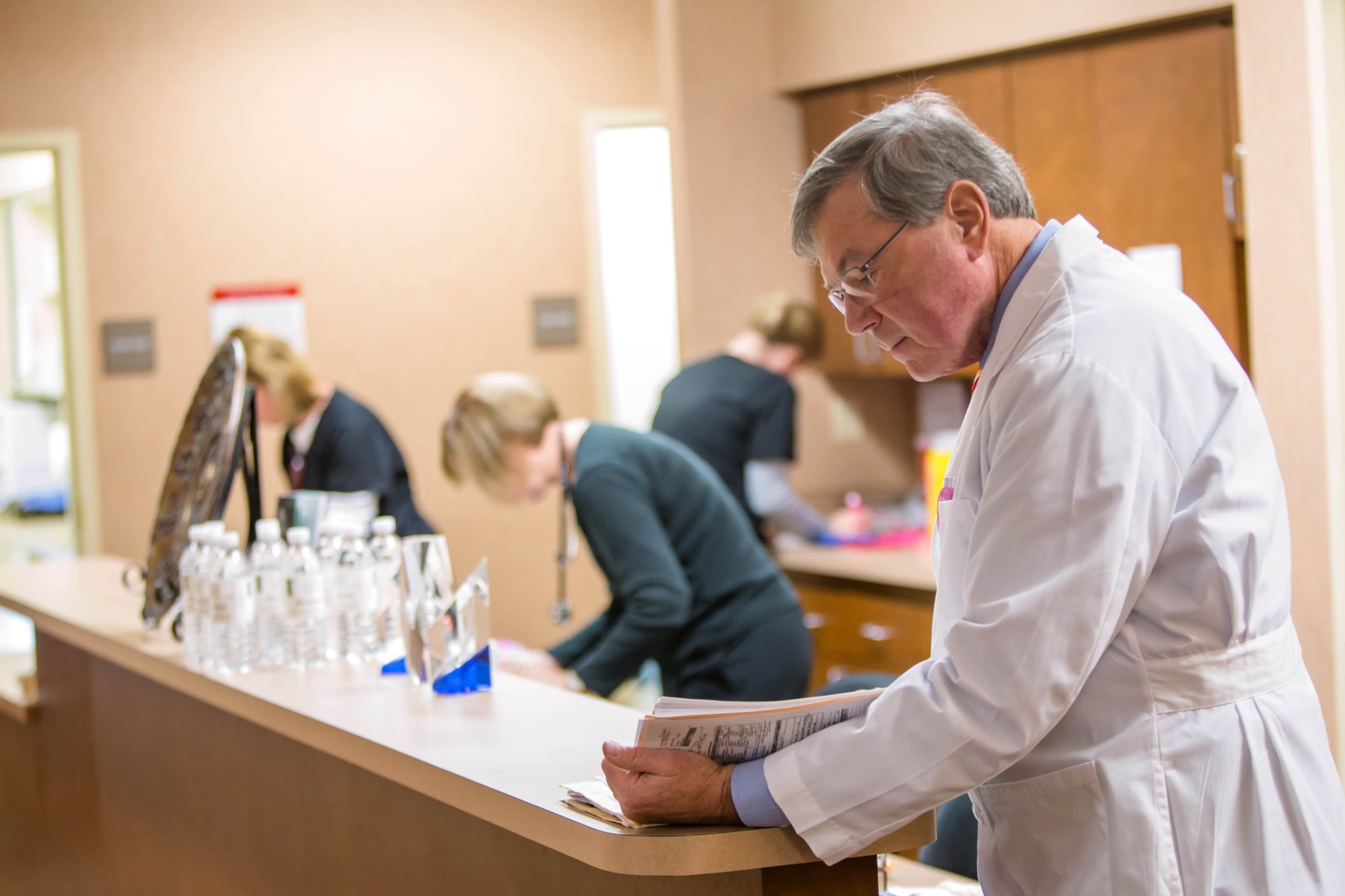 Dr. E. D. Deloach looks over a file at the nurse’s station inside Savannah Plastic Surgery, located on Hodgson Memorial Drive in Savannah Georgia.