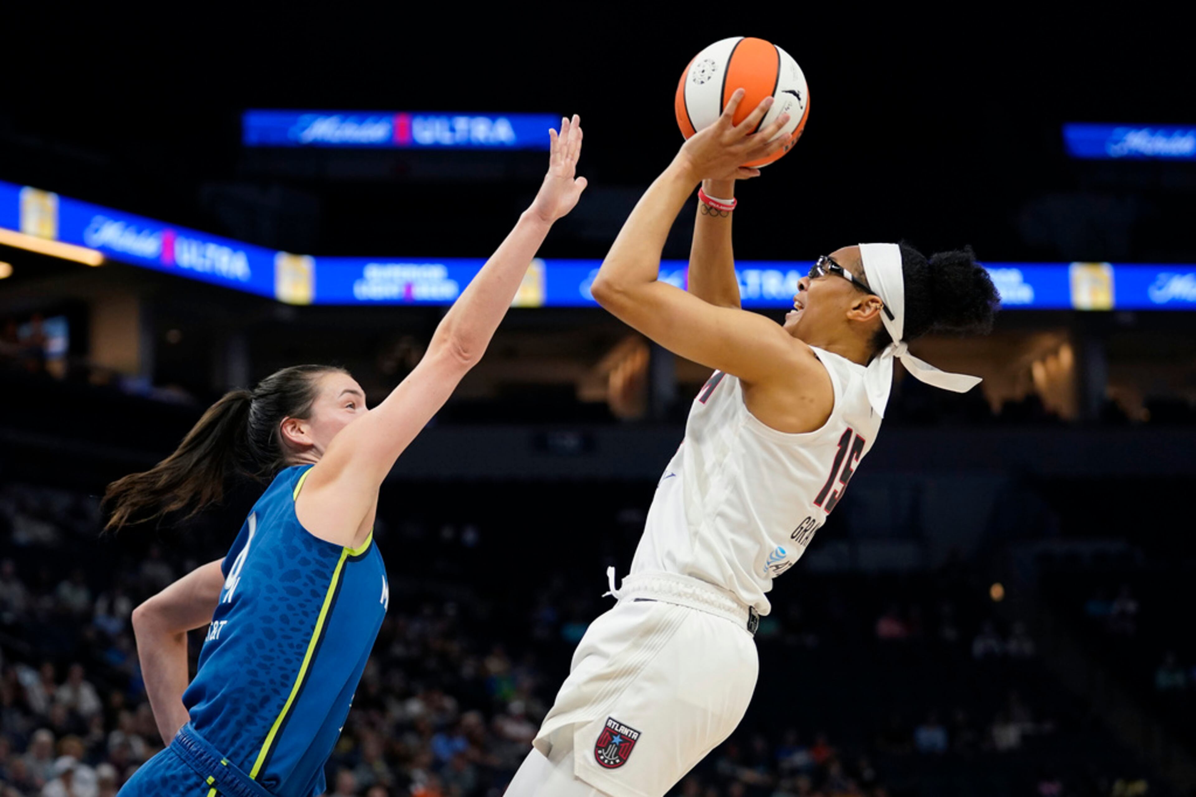 Atlanta Dream guard Allisha Gray, right, shoots while defended by Minnesota Lynx forward Bridget Carleton, left, during the first half of a WNBA basketball game Friday, Sept. 1, 2023, in Minneapolis. (AP Photo/Abbie Parr)