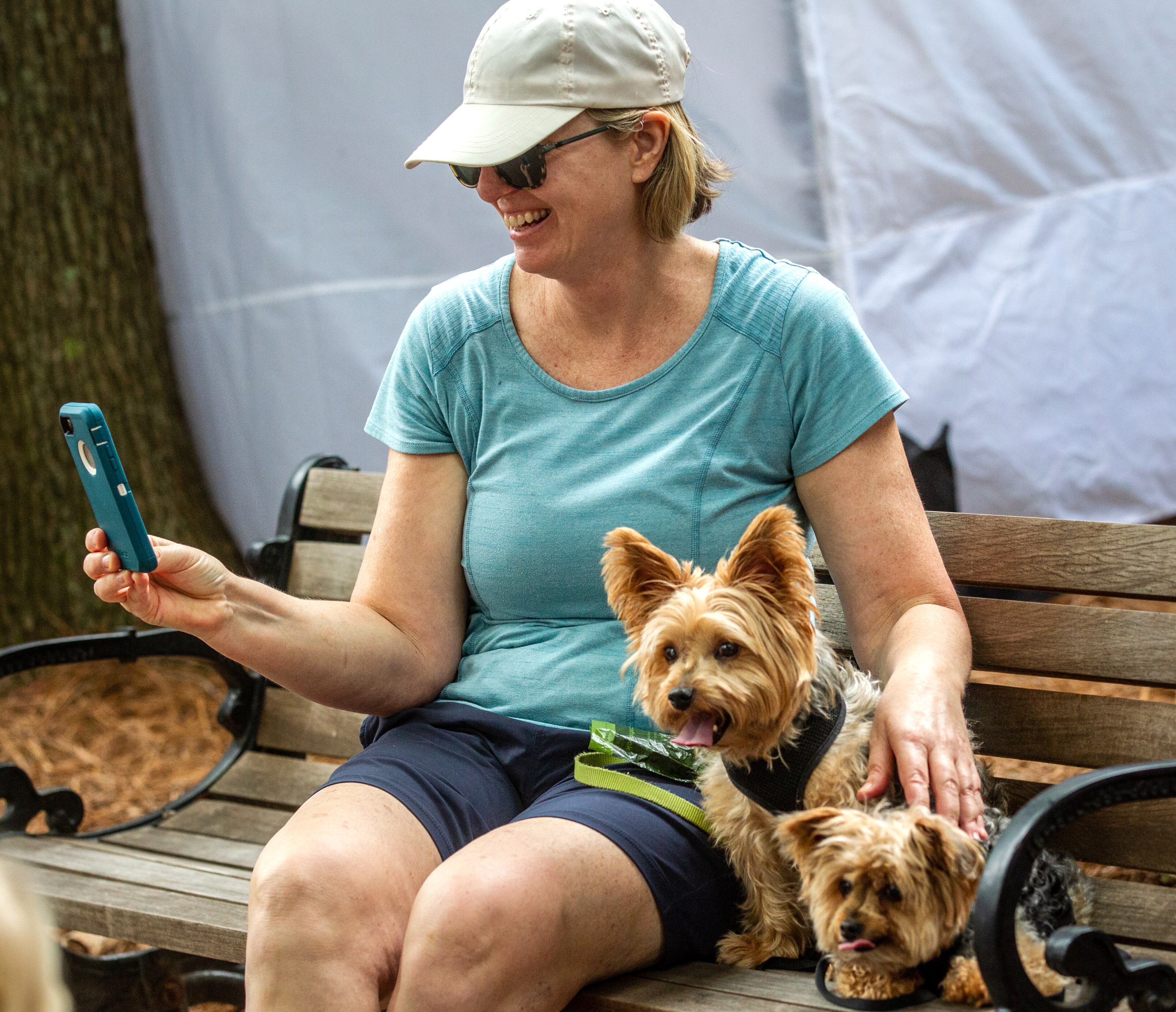 Jamie Fulford sits on a bench with her two dogs, Theo and Bruiser, during the Roswell Spring Arts and Crafts Festival on Sunday, June 13, 2021. (Photo: Steve Schaefer for The Atlanta Journal-Constitution)