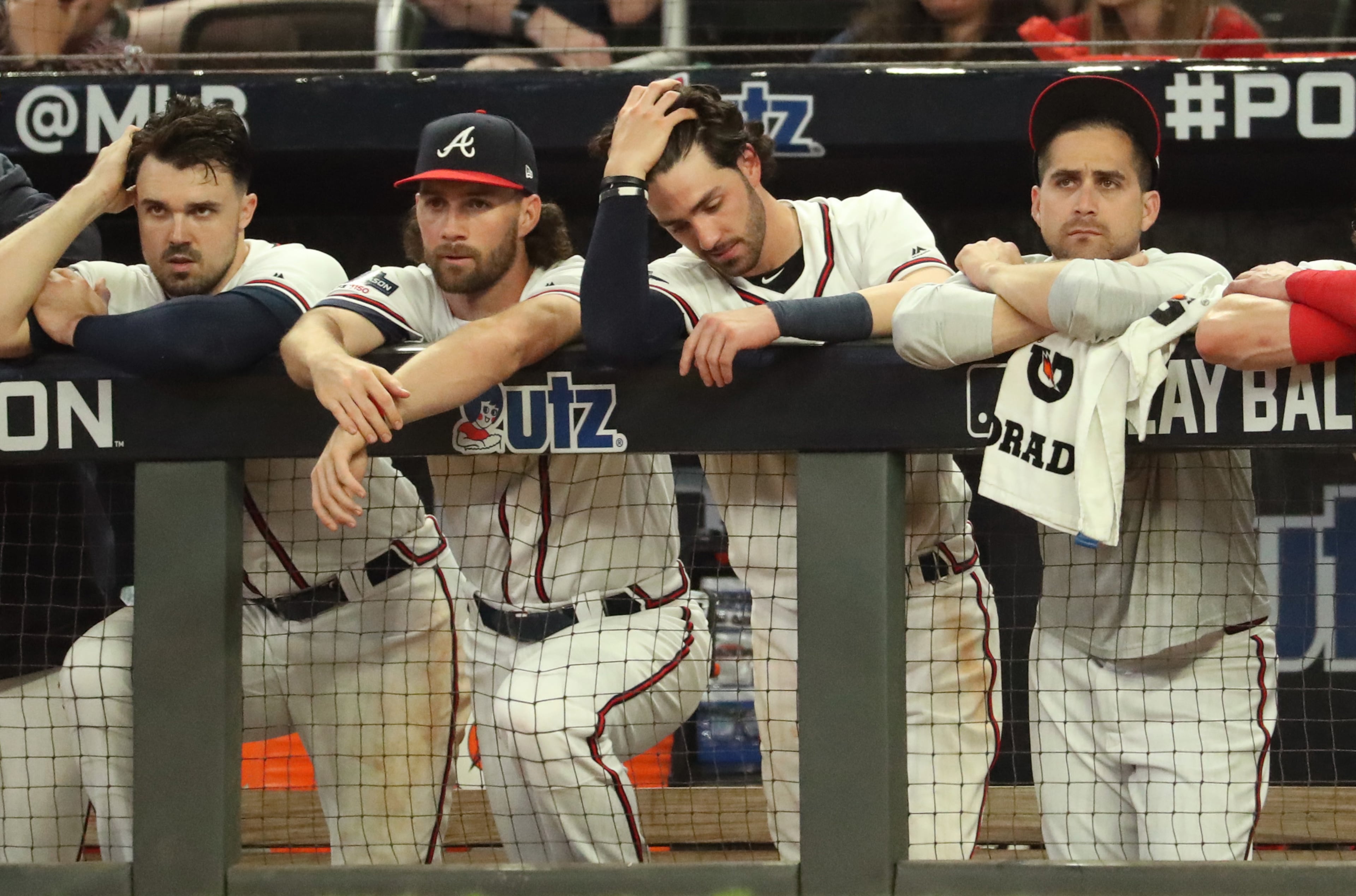 Braves shortstop Dansby Swanson, center, and teammates react during their loss. (JASON GETZ/SPECIAL TO THE AJC)