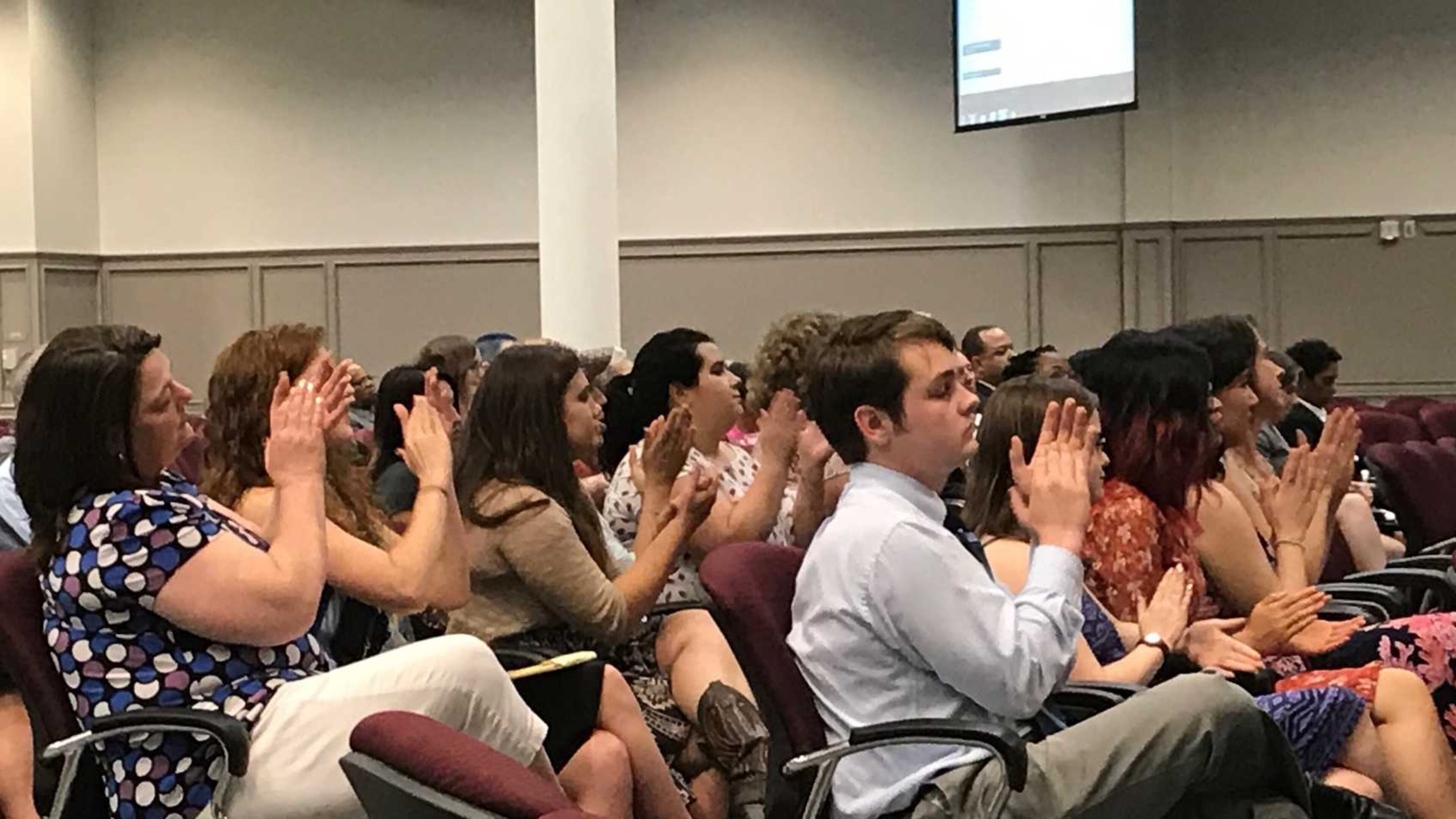 Parents and students applaud one of several speakers who complained about some sex education lessons taught by a group during the June 15, 2017 Gwinnett County school board meeting. ERIC STIRGUS / ESTIRGUS@AJC.COM